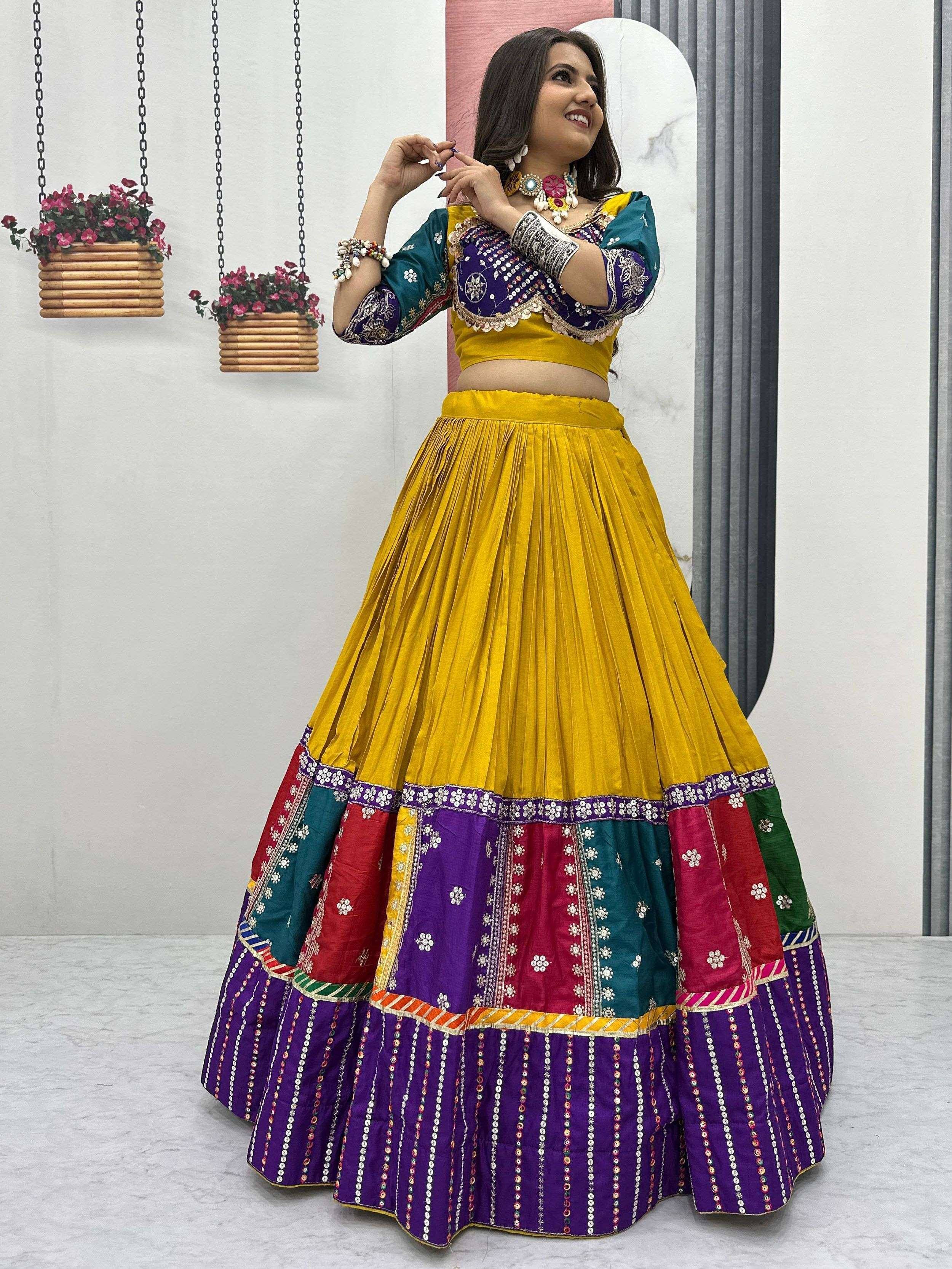 Vibrant yellow and purple embroidered lehenga choli with mirror work, perfect for Indian ethnic wear occasions