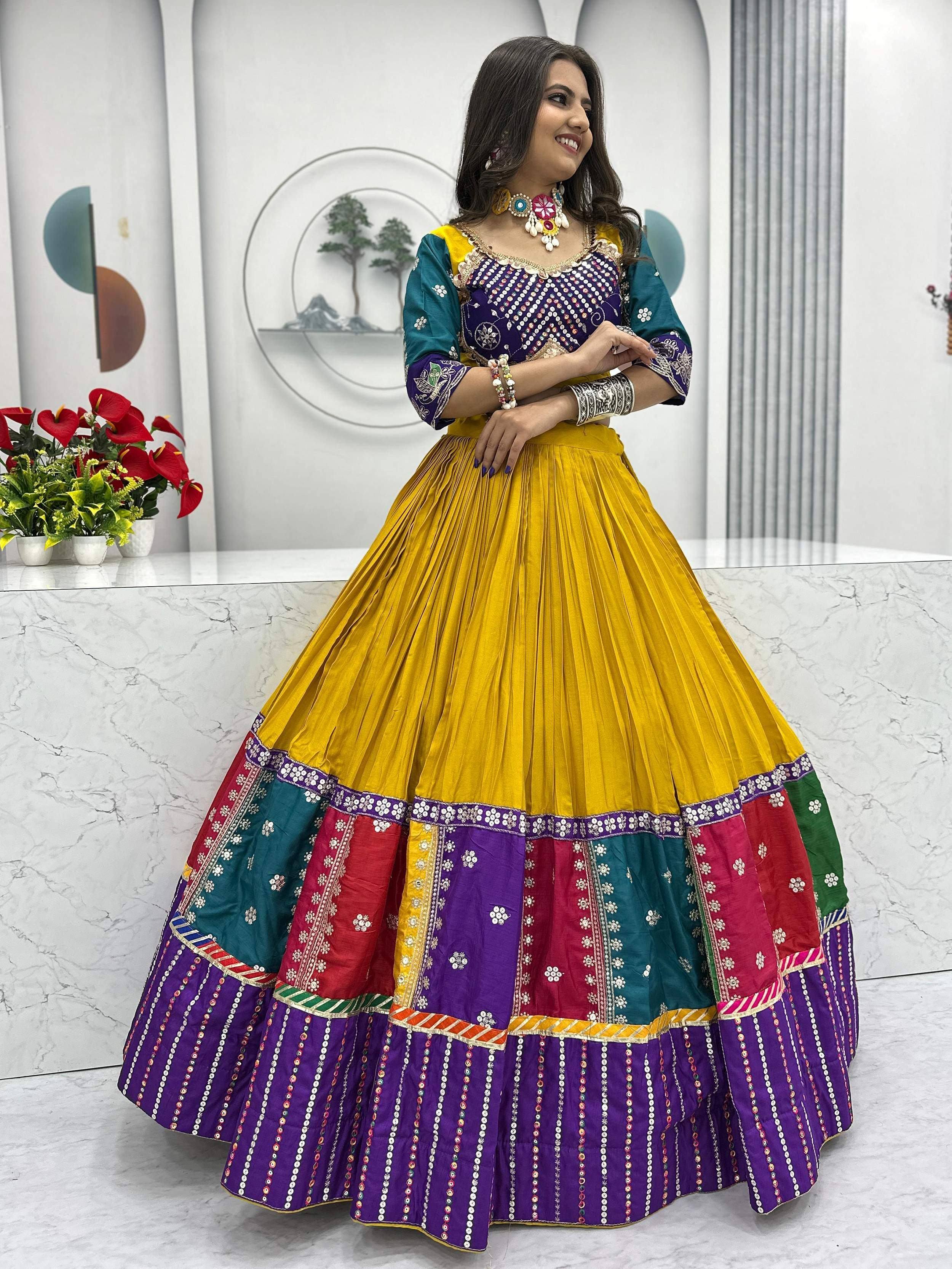 Vibrant yellow and purple embroidered lehenga choli with mirror work, perfect for Indian ethnic wear occasions.