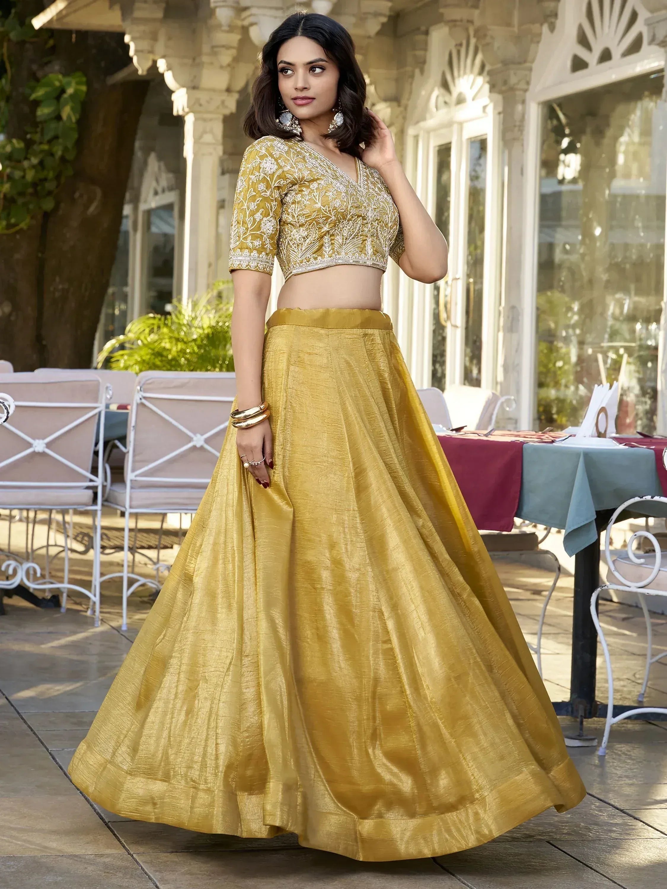 Golden embroidered lehenga choli with floral detailing, perfect for Indian ethnic occasions and weddings.