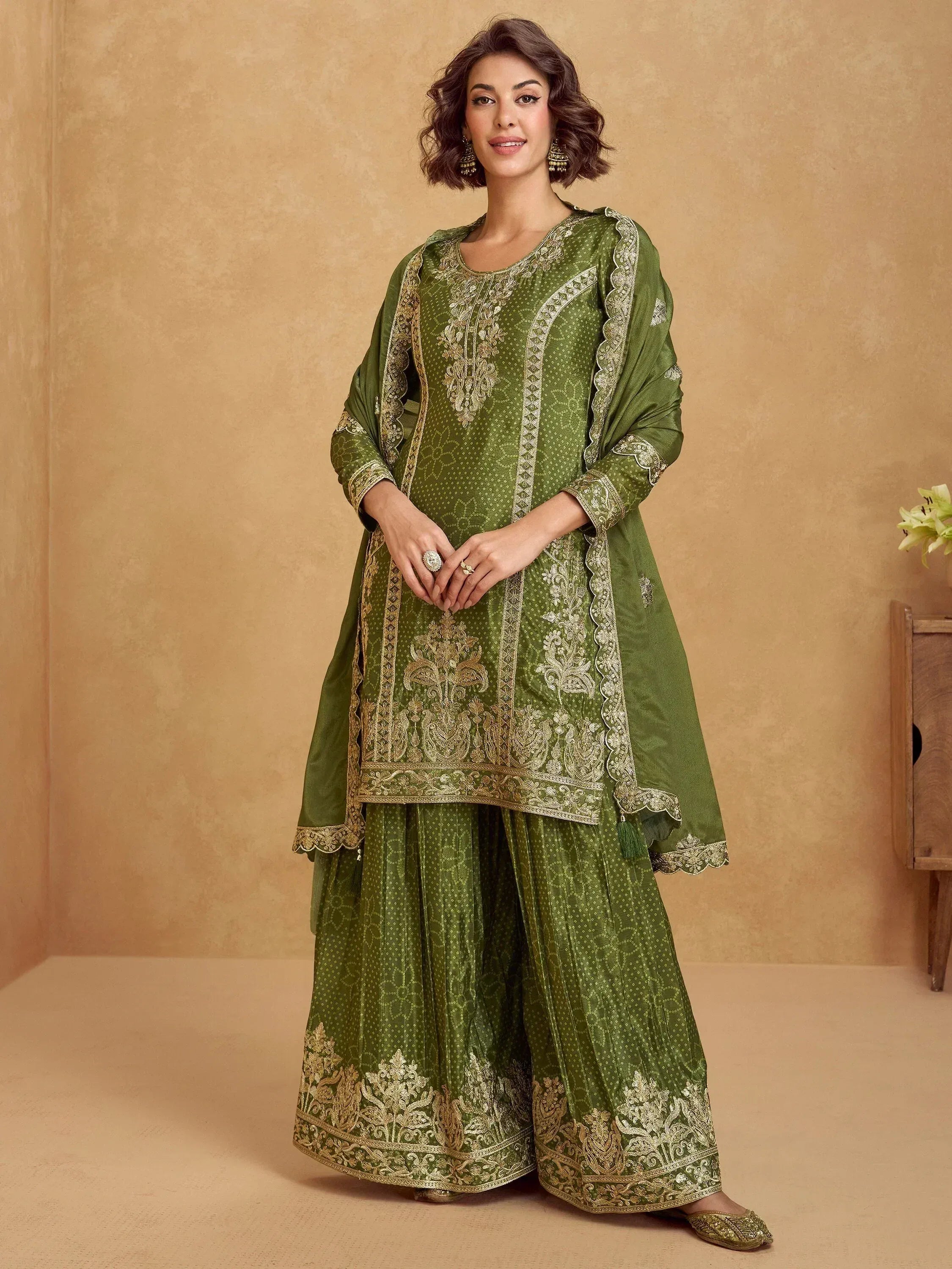 Green embroidered salwar kameez with gold detailing, perfect for Indian ethnic wear occasions.