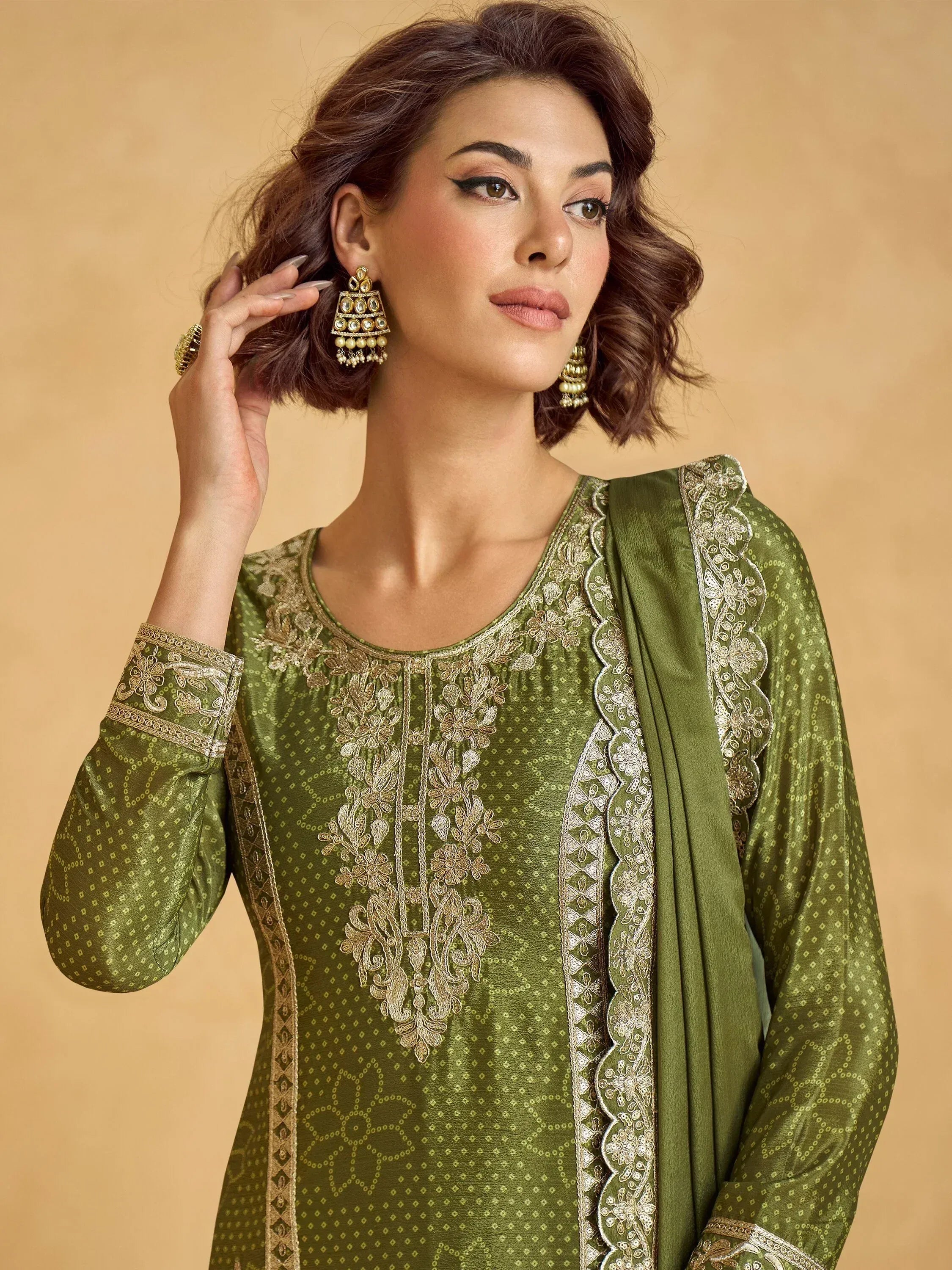 Olive green embroidered salwar kameez with gold detailing, perfect for Indian ethnic wear occasions.