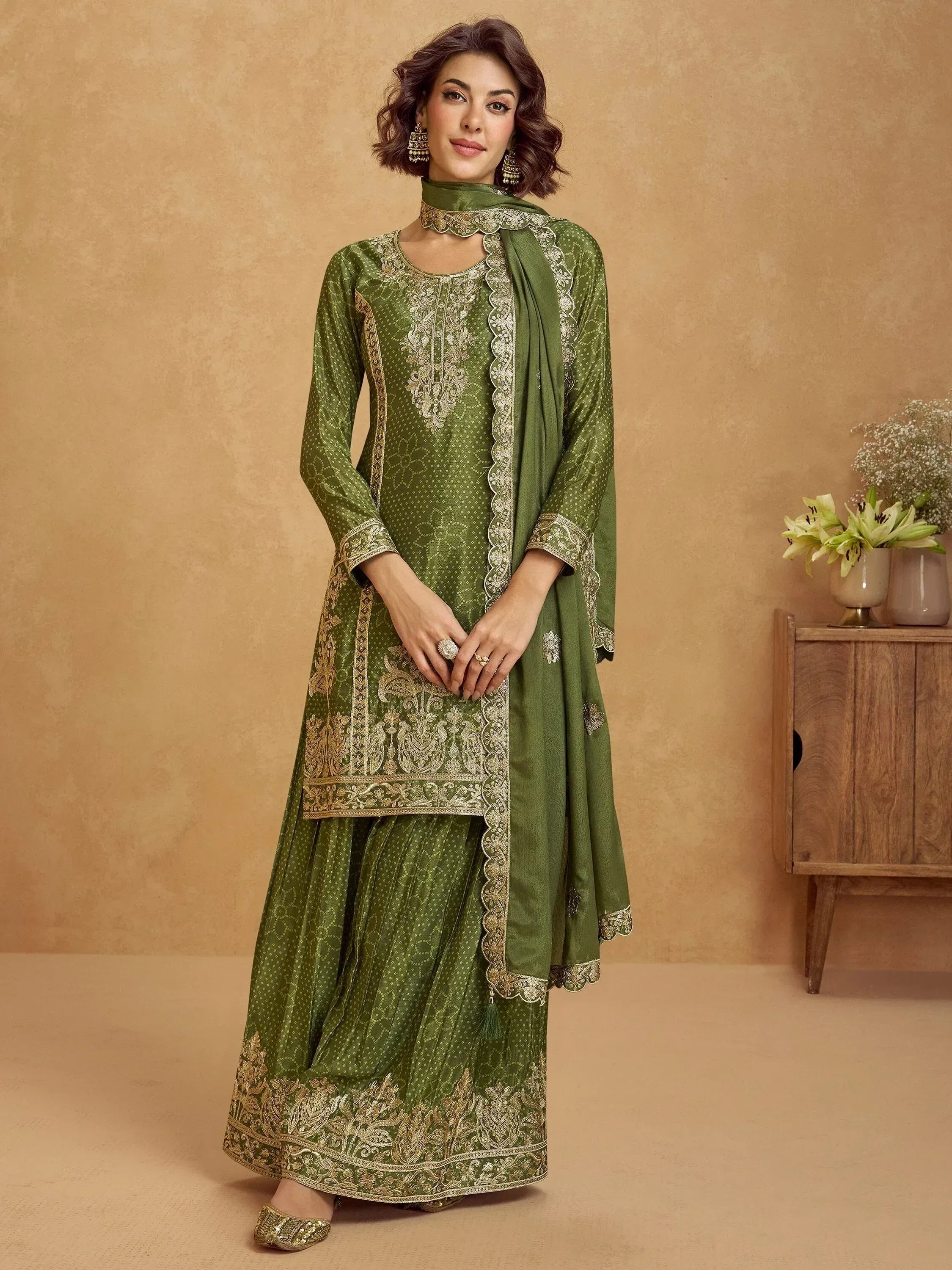 Olive green embroidered salwar kameez with gold detailing, perfect for Indian ethnic wear occasions.