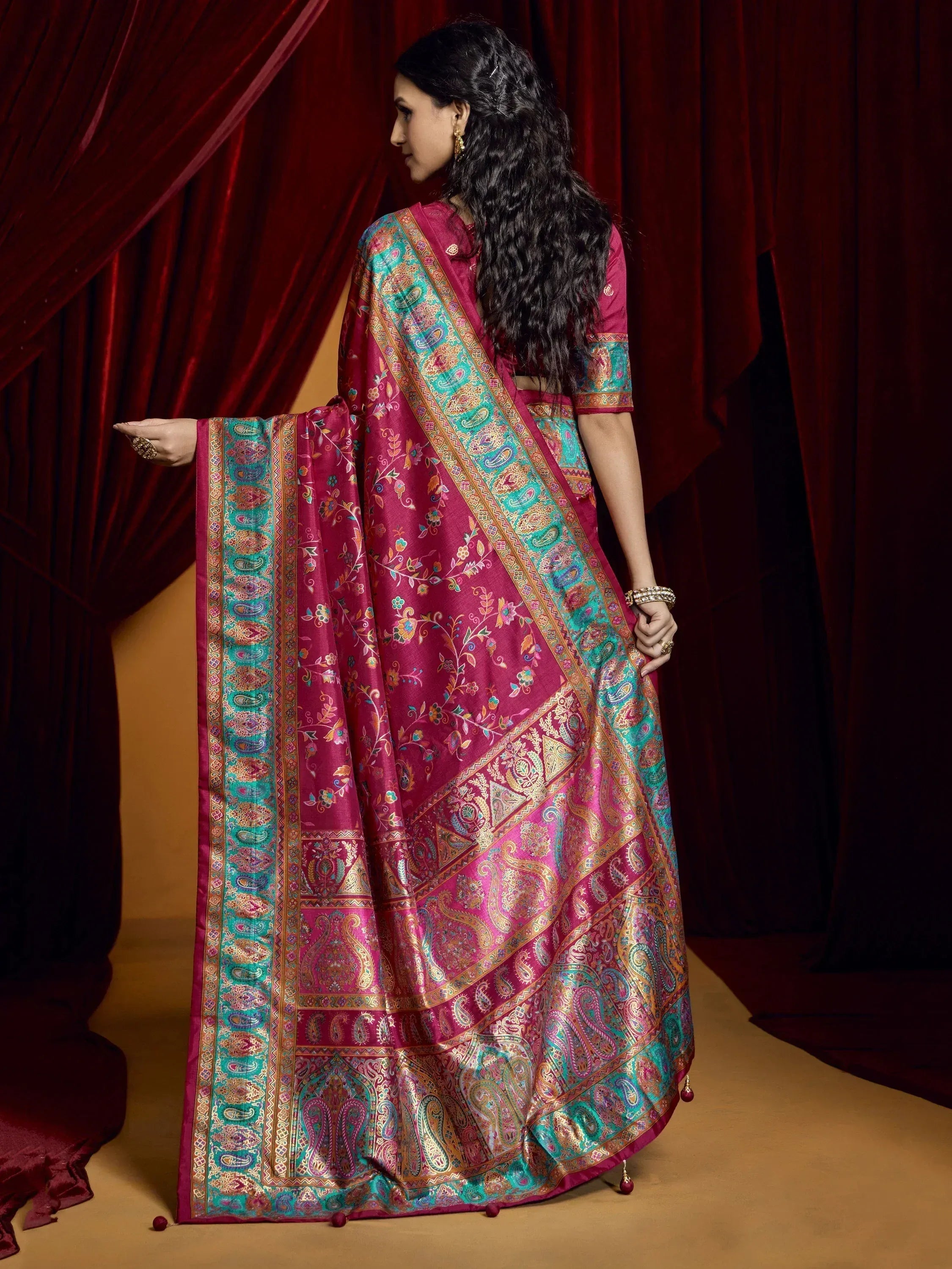 Woman in maroon and teal designer saree with paisley print, ethnic Indian wear for festive occasions