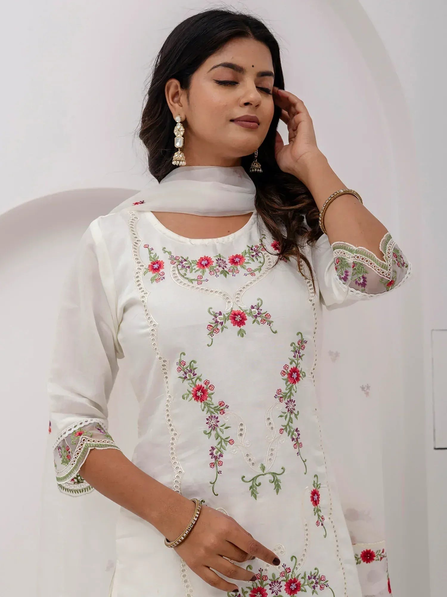 White embroidered kurti with floral design, perfect for Indian ethnic wear and festive occasions.