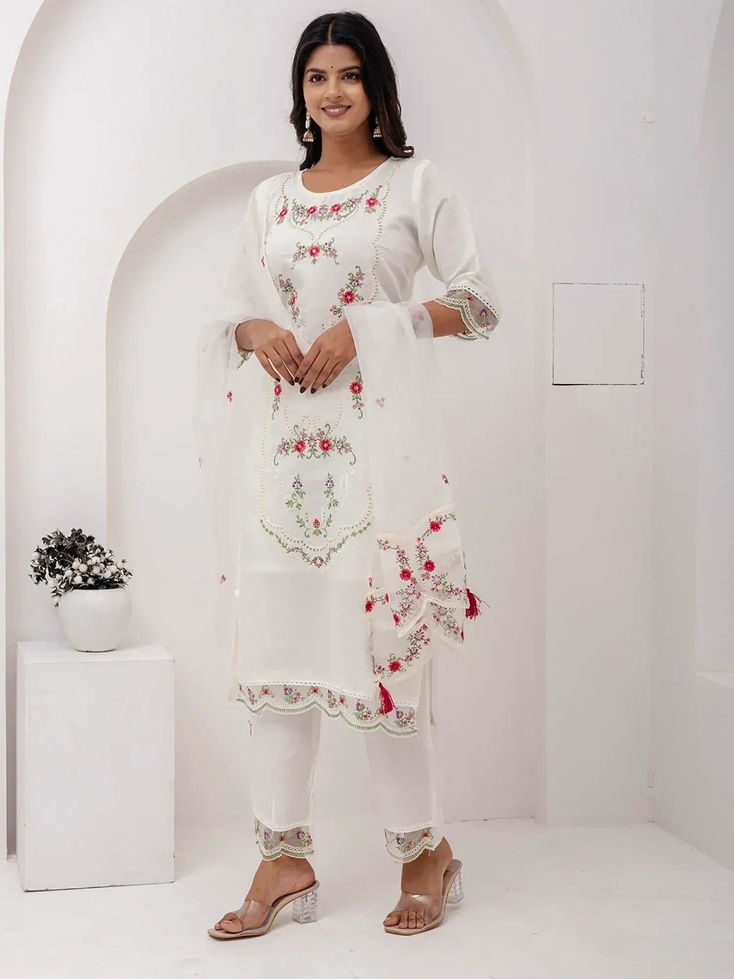 White embroidered salwar kameez with floral design, perfect for ethnic wear and festive occasions.
