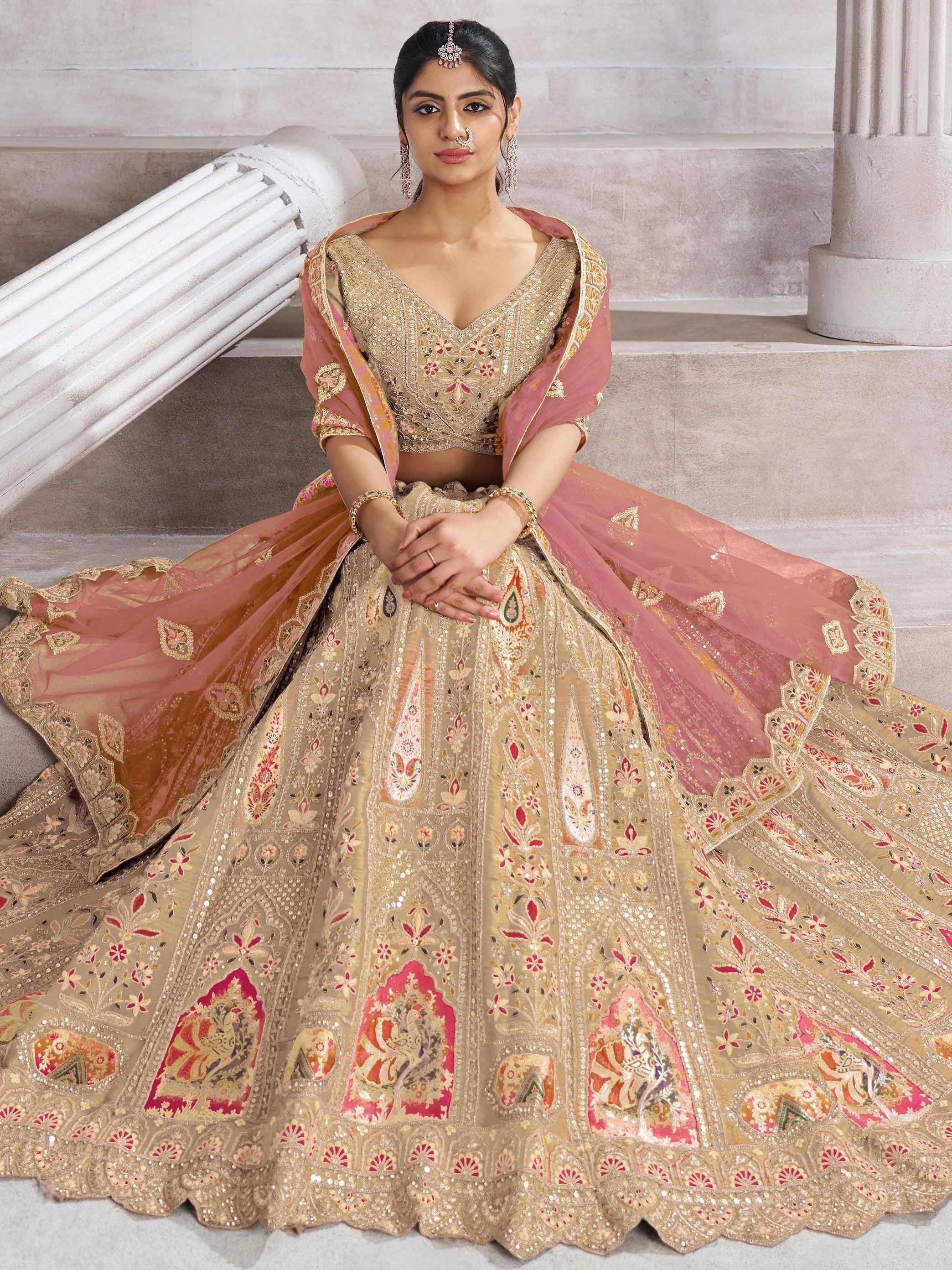 Elegant gold and pink embroidered lehenga choli with floral motifs, perfect for Indian weddings and festive occasions.