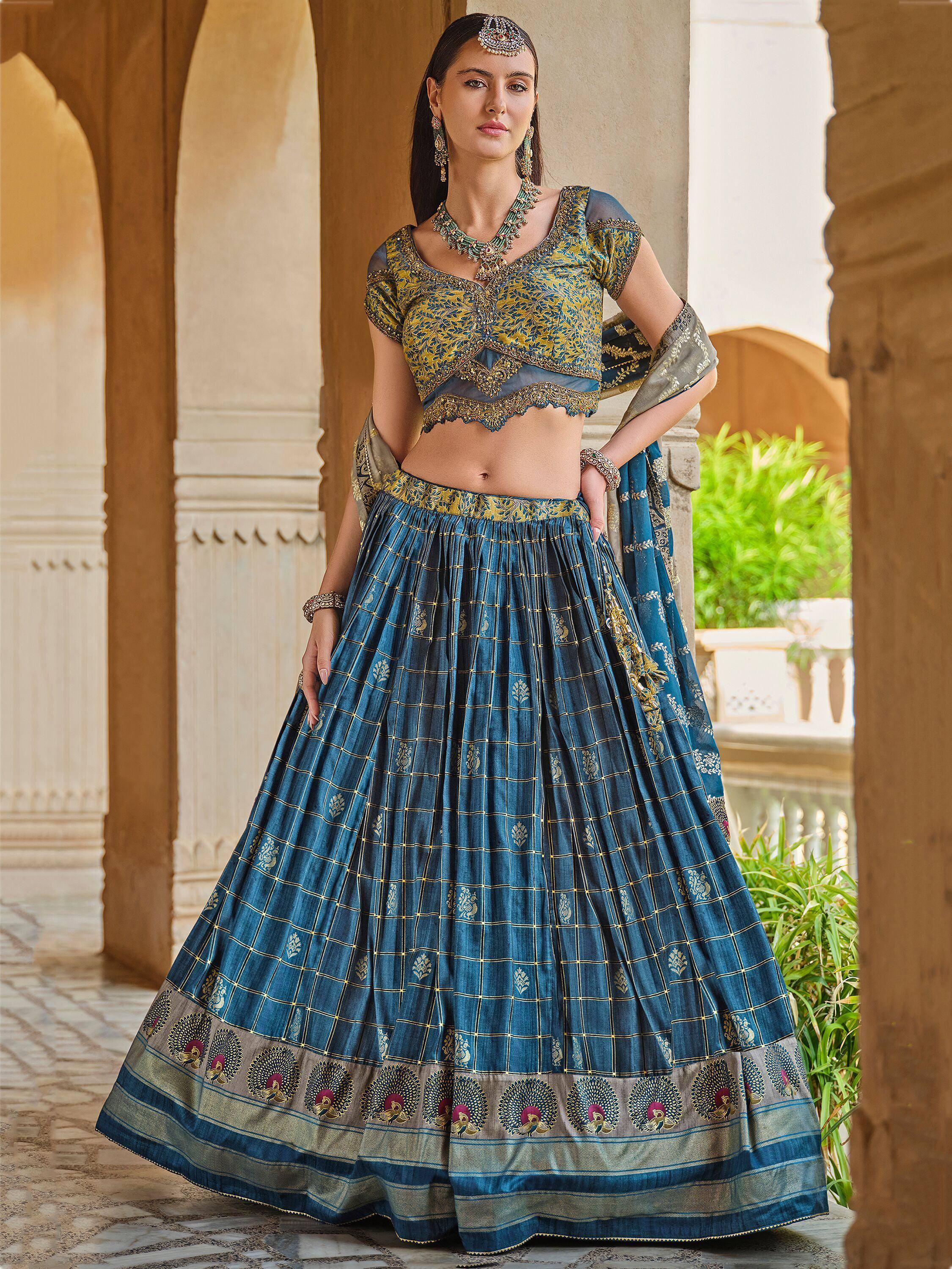 Blue and gold designer lehenga choli with intricate embroidery, perfect for Indian ethnic wear occasions.