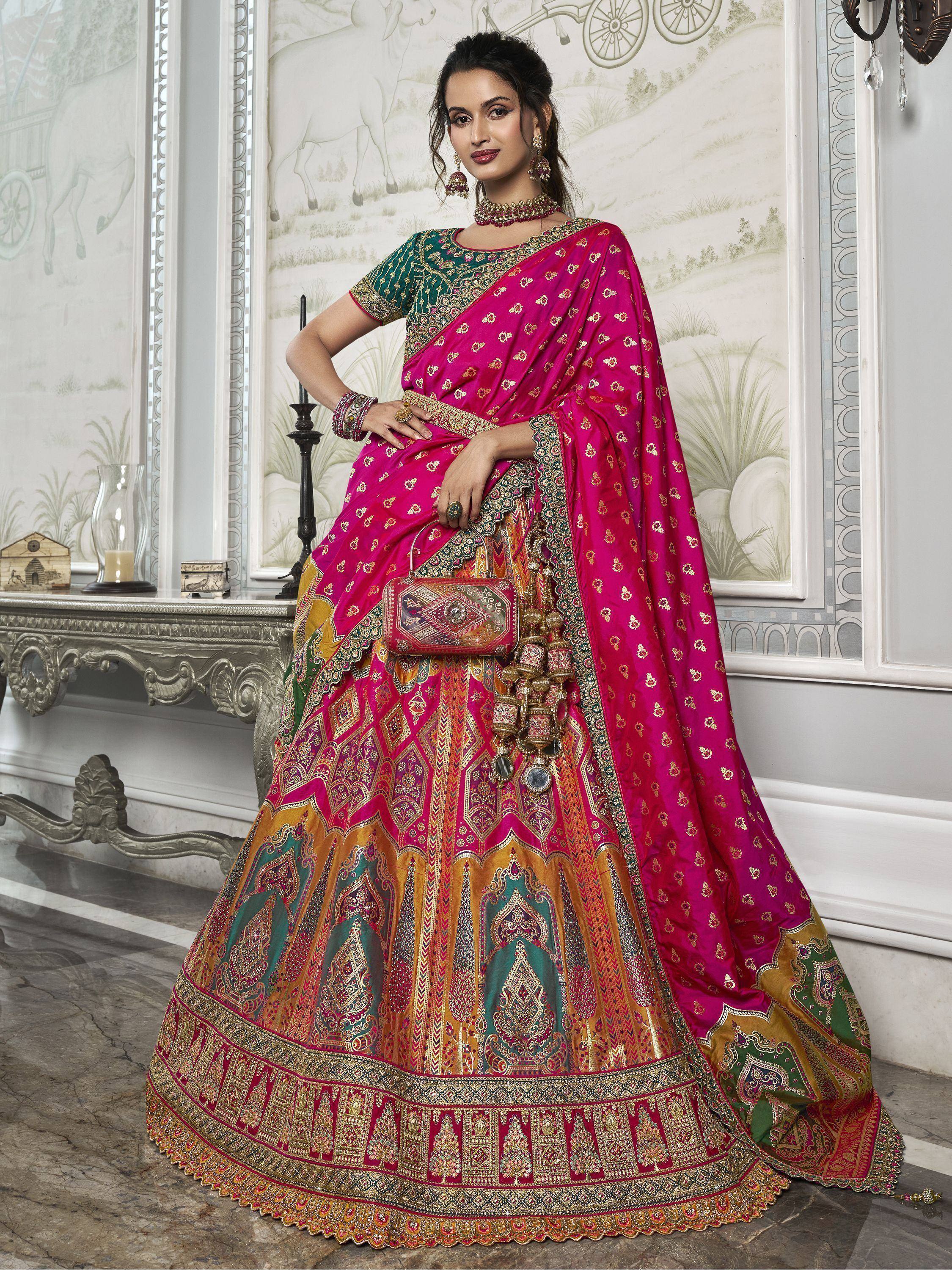 Pink and green designer lehenga choli with intricate gold embroidery, perfect for Indian weddings and festive occasions.