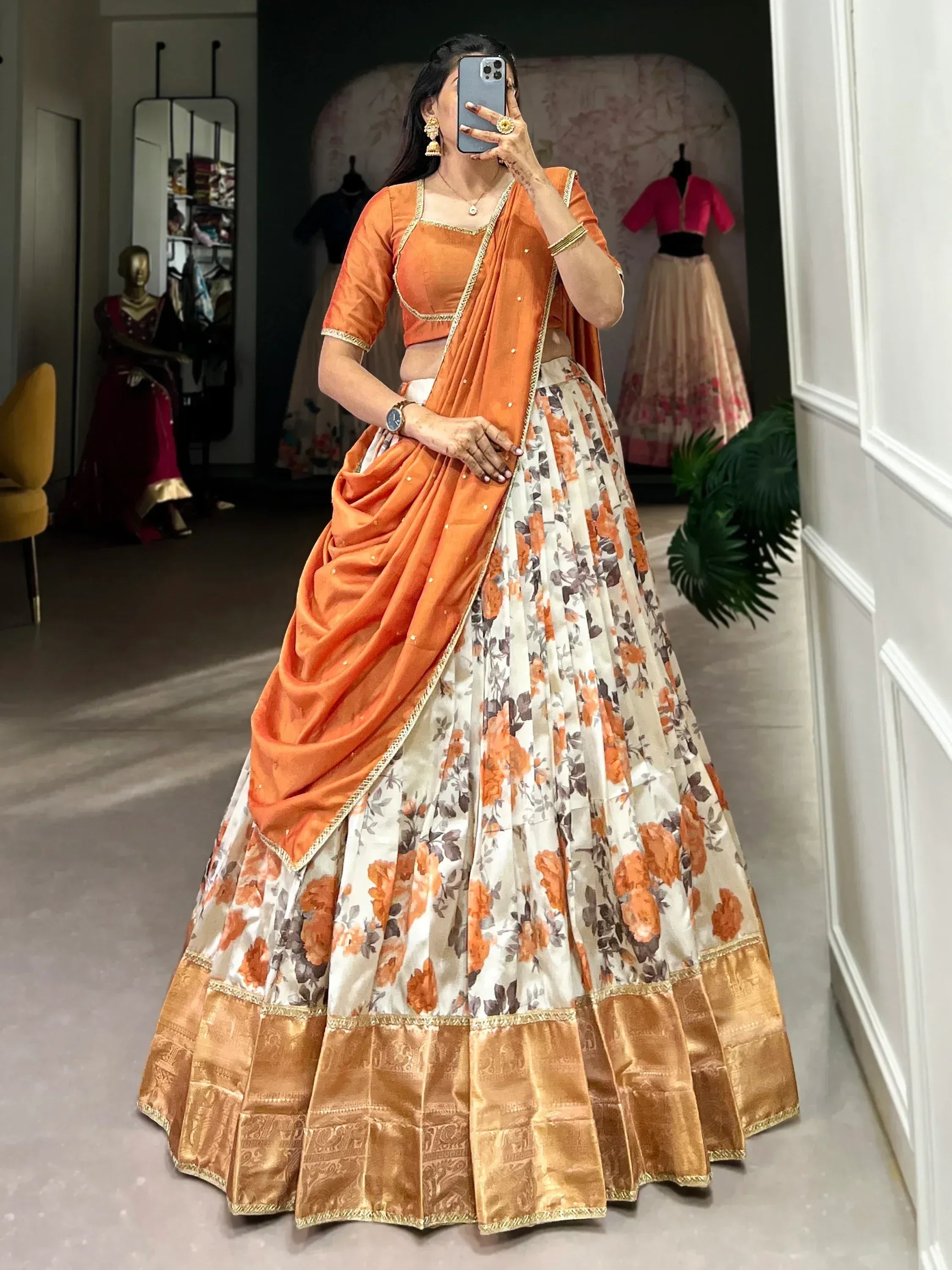 Orange floral lehenga choli with golden border, perfect for Indian ethnic wear