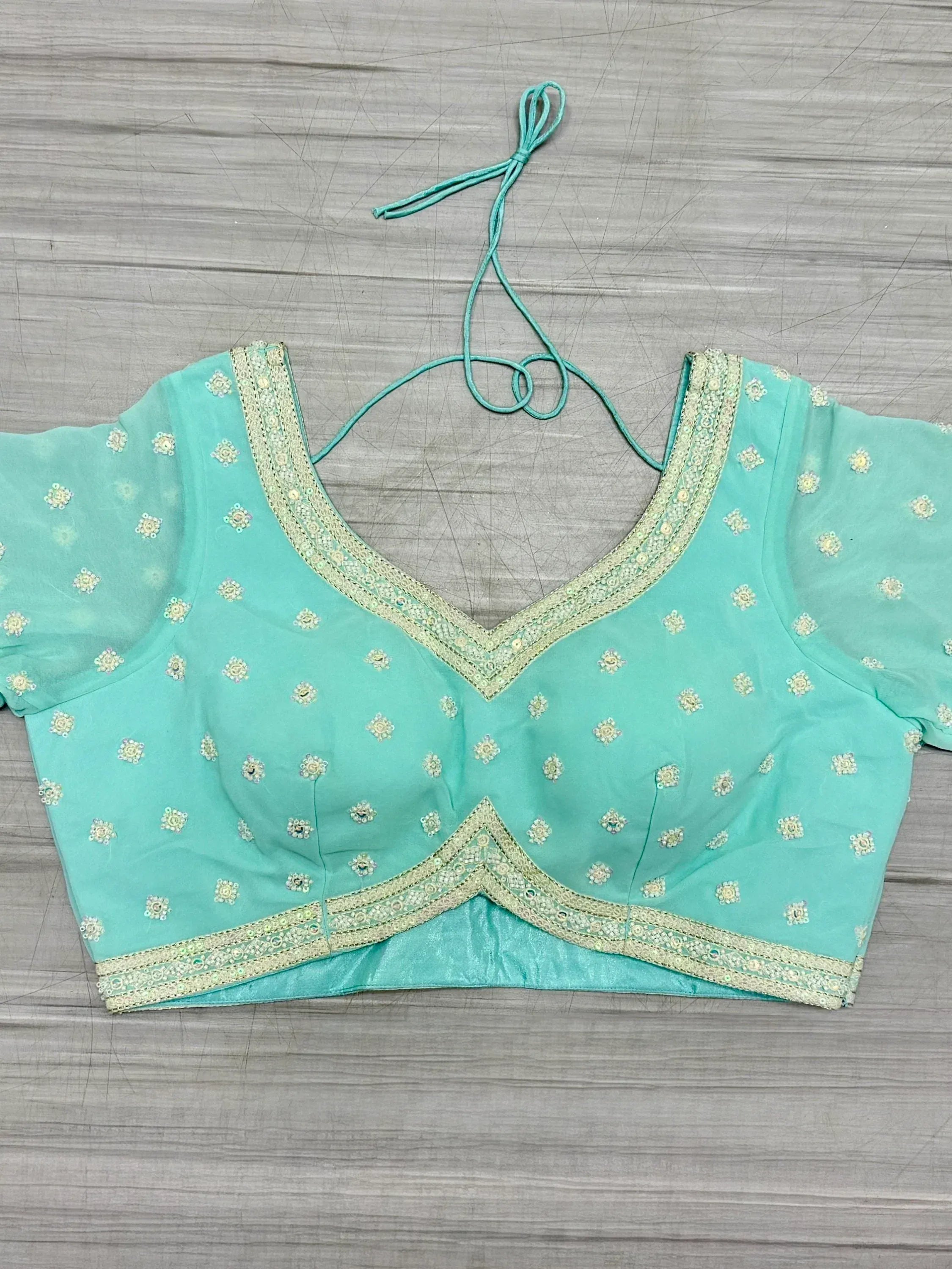 Mint green embroidered blouse with gold trim, perfect for lehenga choli or saree outfits