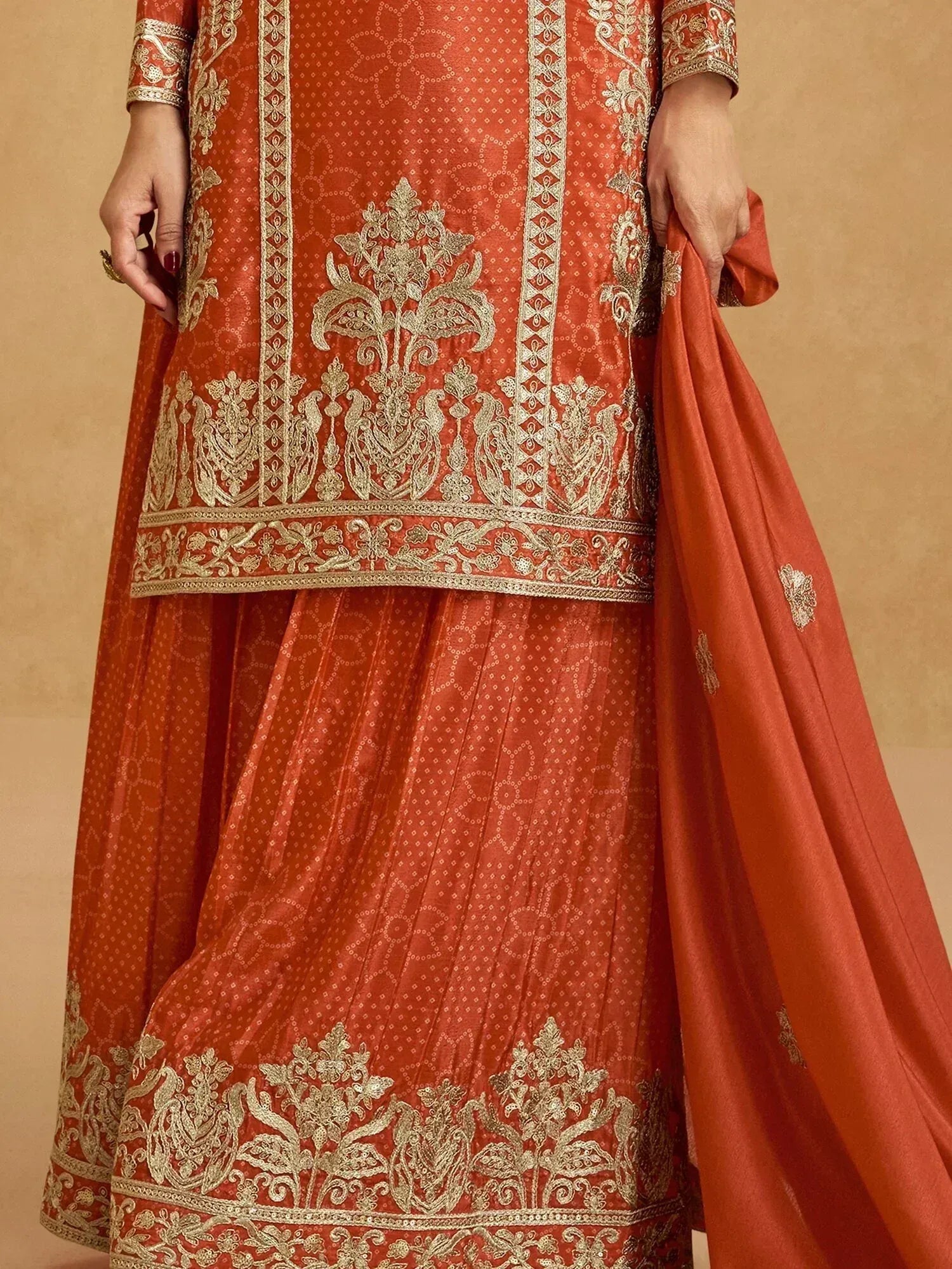 Orange ethnic lehenga choli with gold embroidery, perfect for Indian weddings and festive occasions