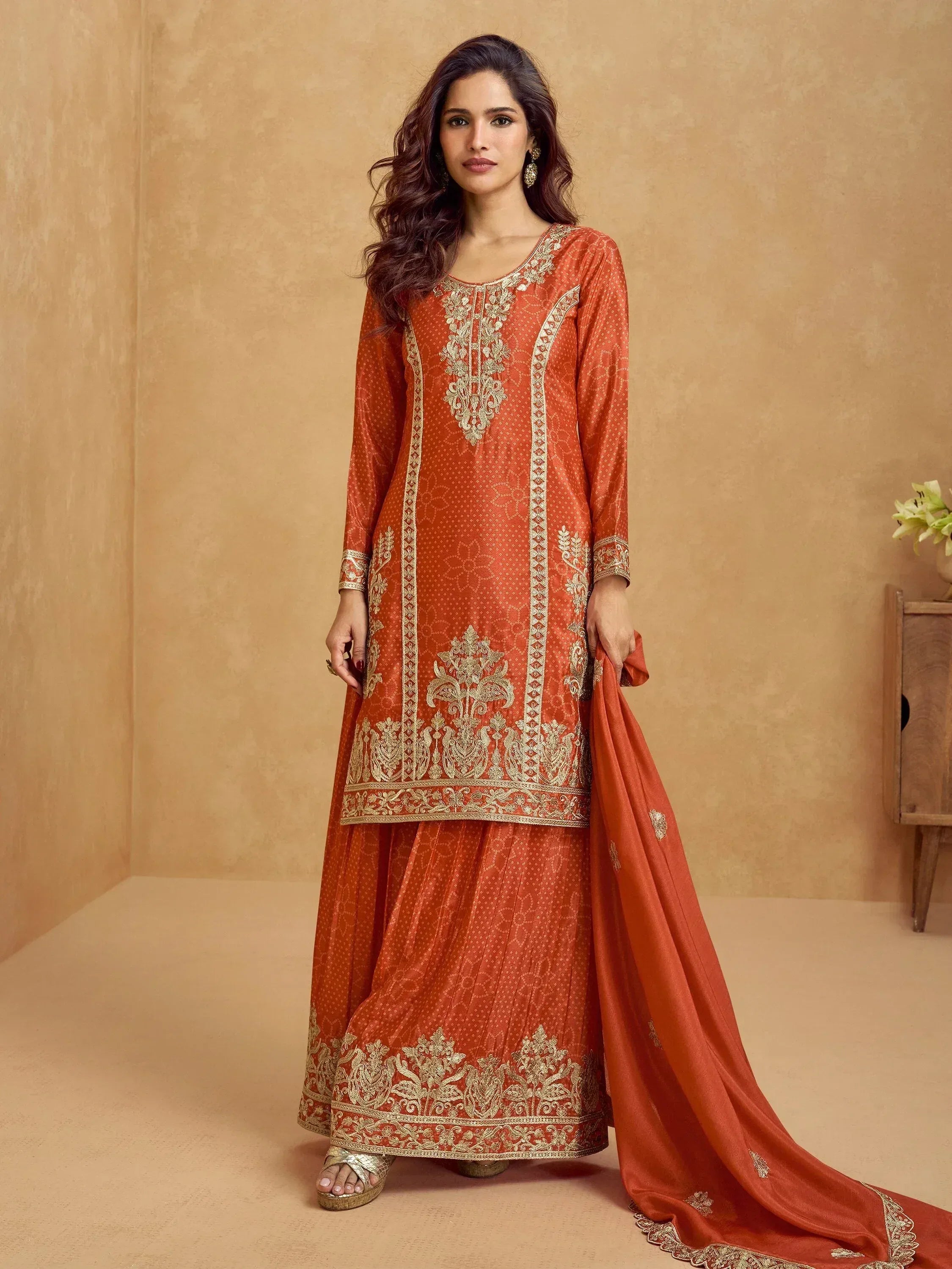 Orange embroidered salwar kameez with gold detailing, perfect for Indian ethnic wear occasions