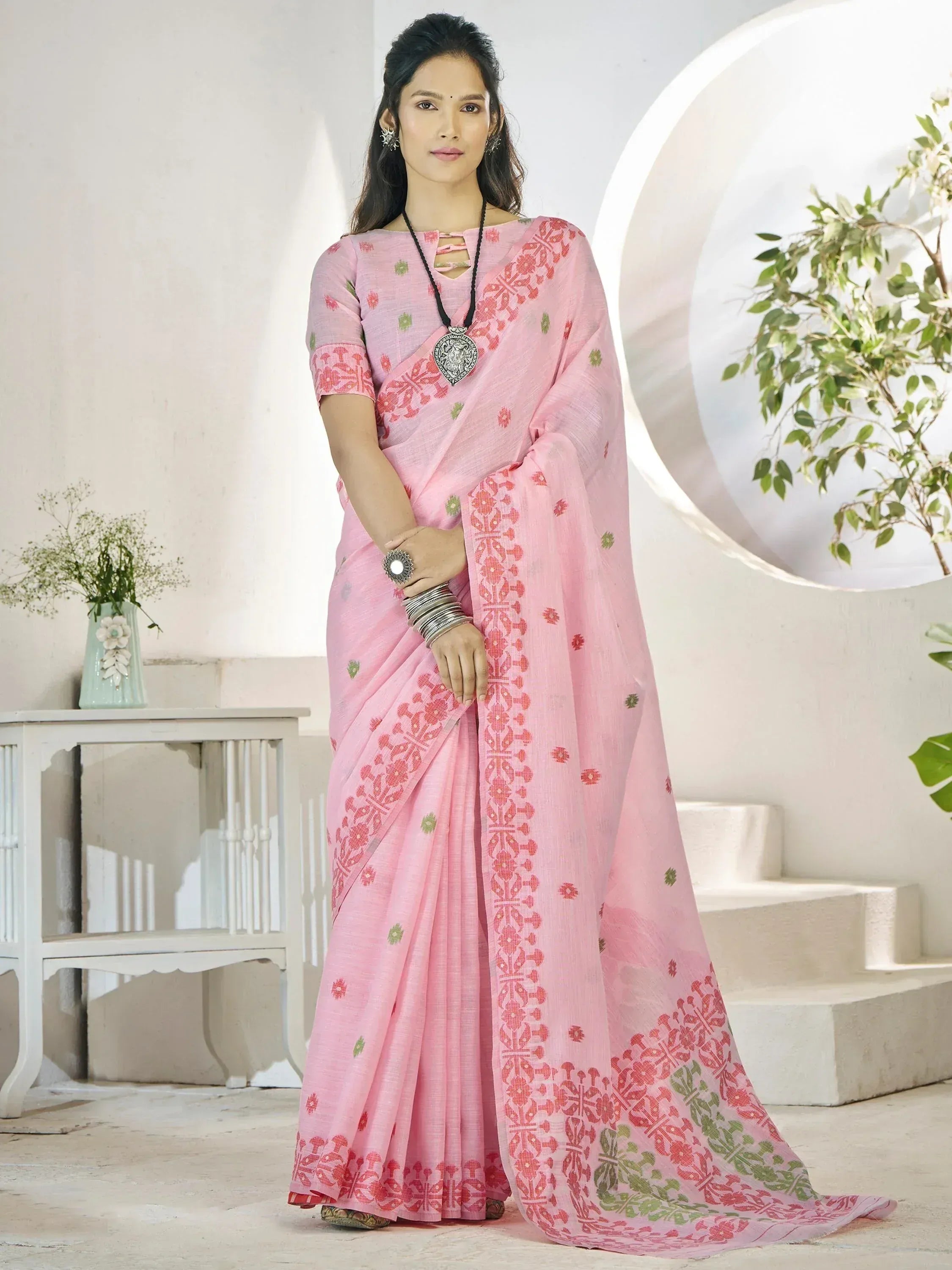 Pink floral printed saree with red and green motifs, stylish ethnic wear for women