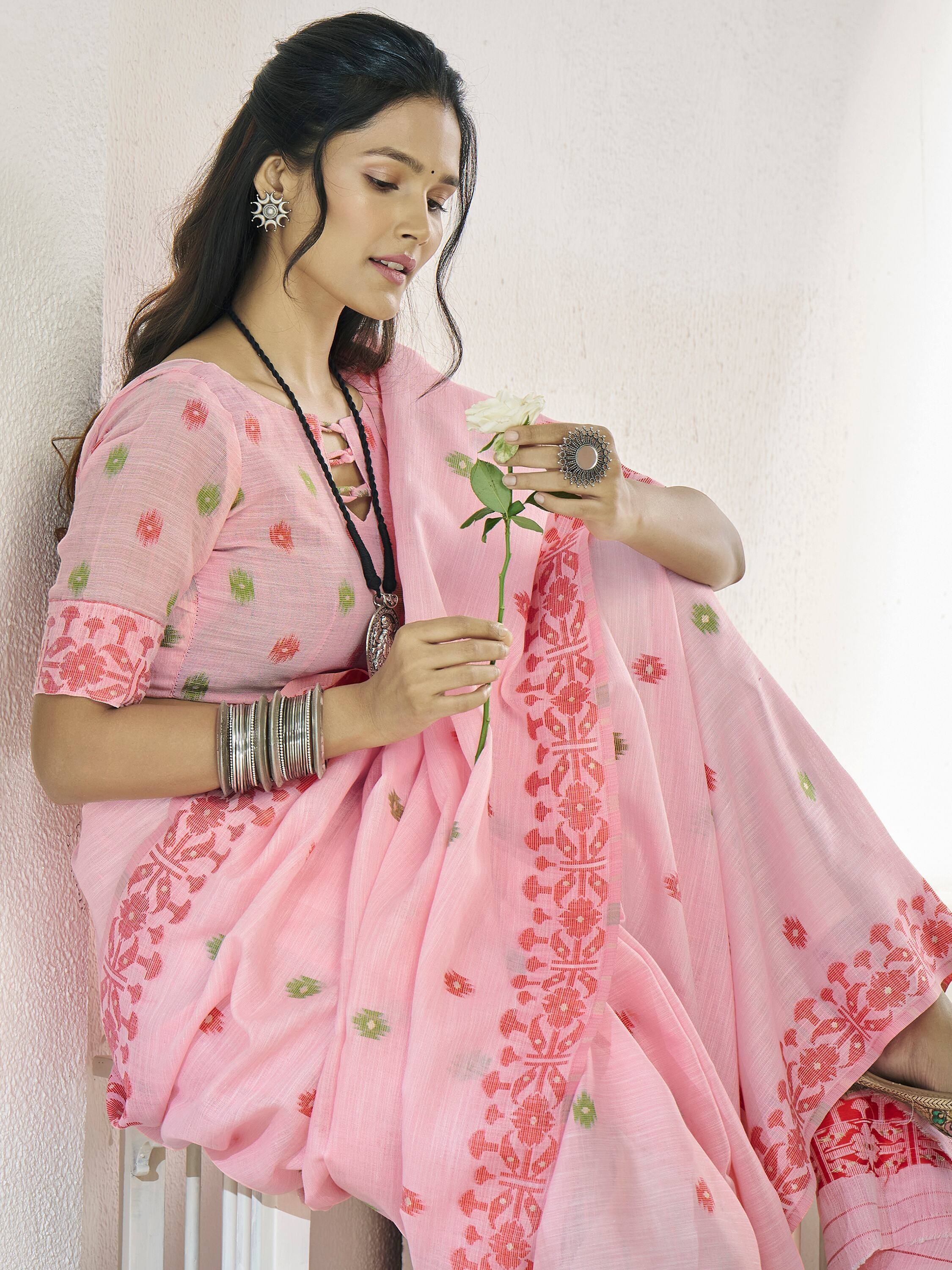 Pink floral ethnic saree with embroidered border, styled with silver jewelry and white rose