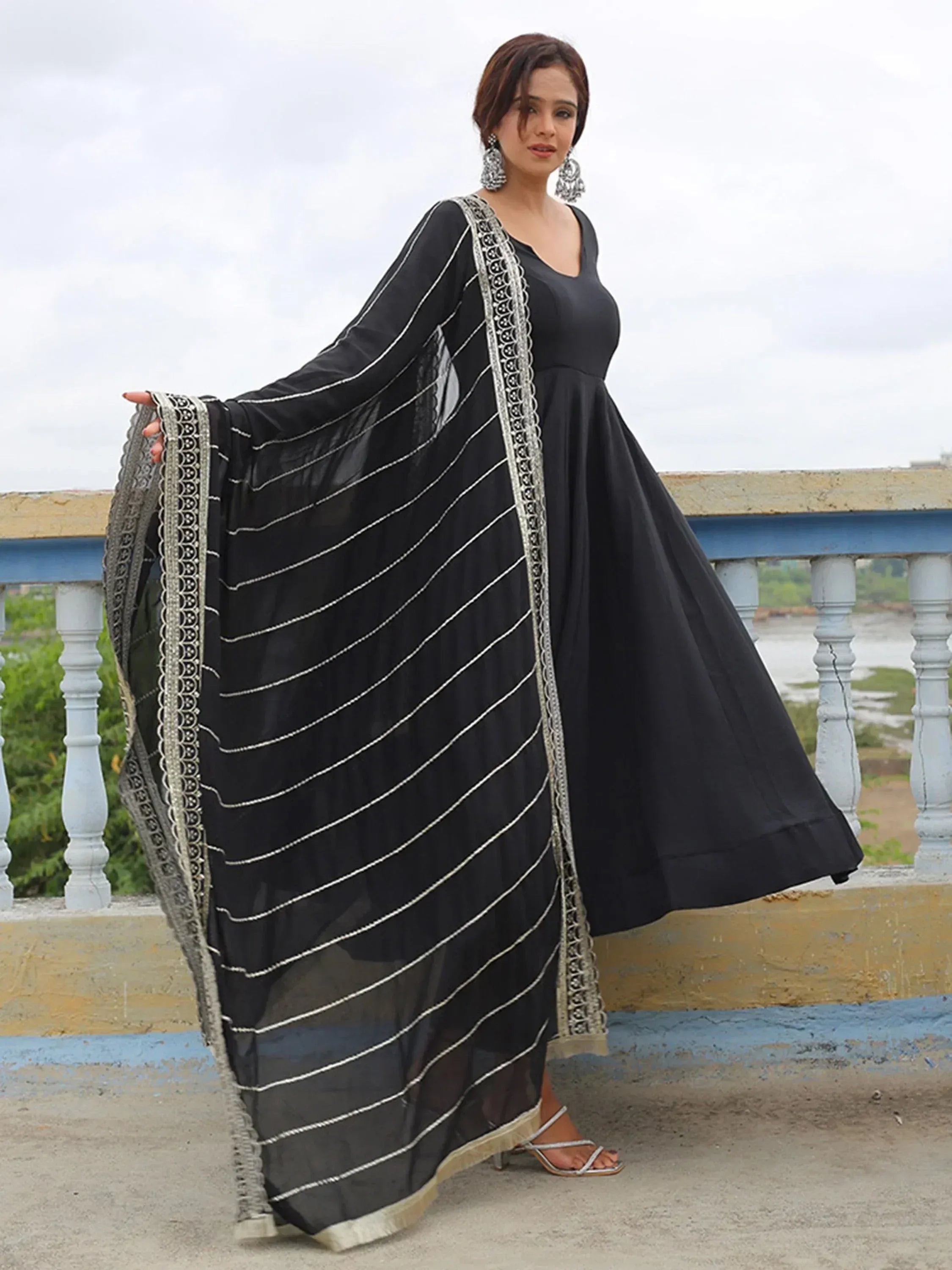 Black ethnic gown with silver striped dupatta, perfect for Indian occasions and festive wear.