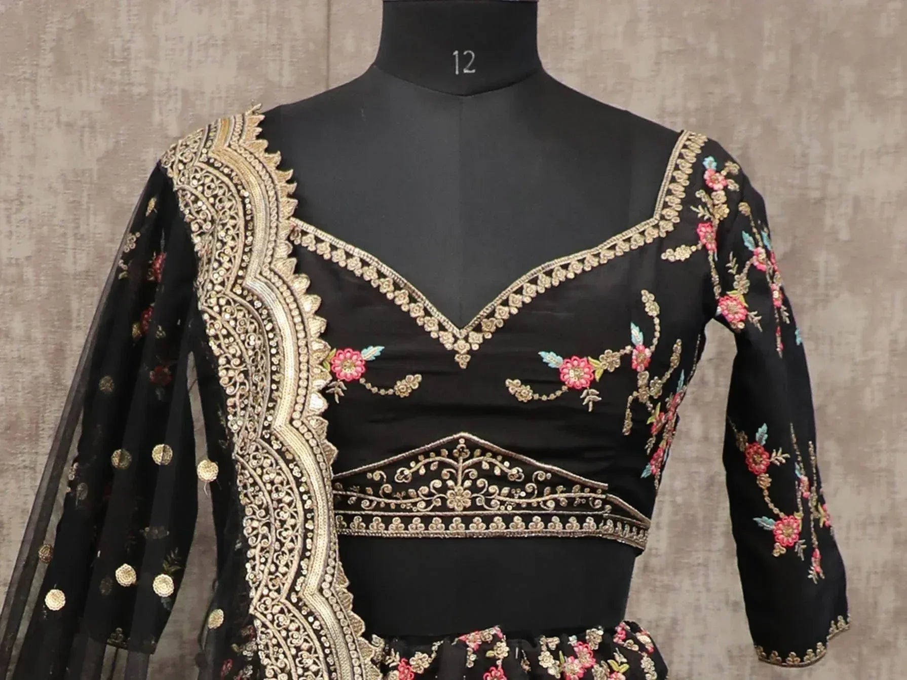 Black embroidered lehenga choli with gold and floral detailing, perfect for Indian ethnic wear occasions
