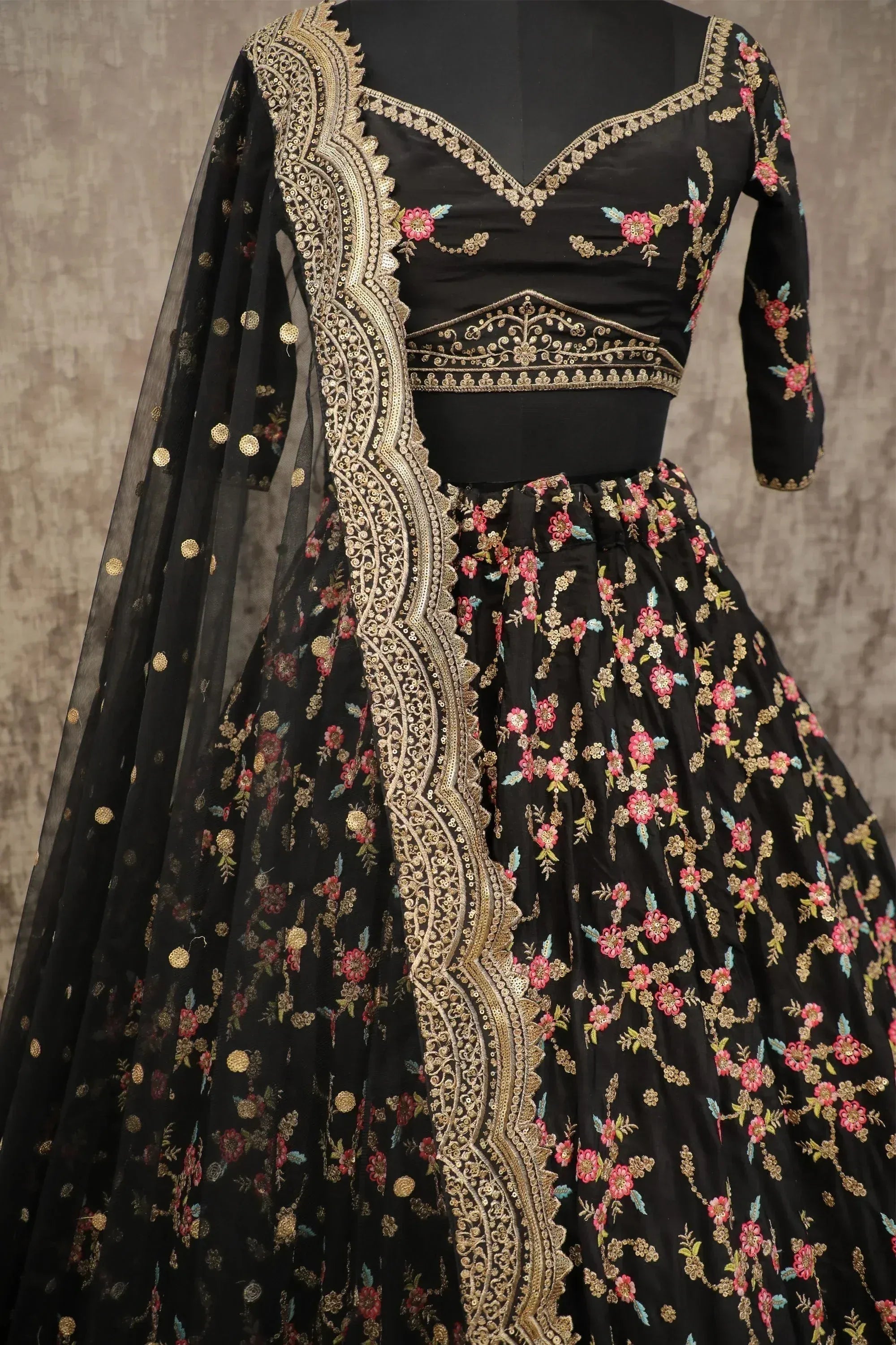 Black floral embroidered lehenga choli with gold detailing and sheer dupatta, Indian ethnic wear