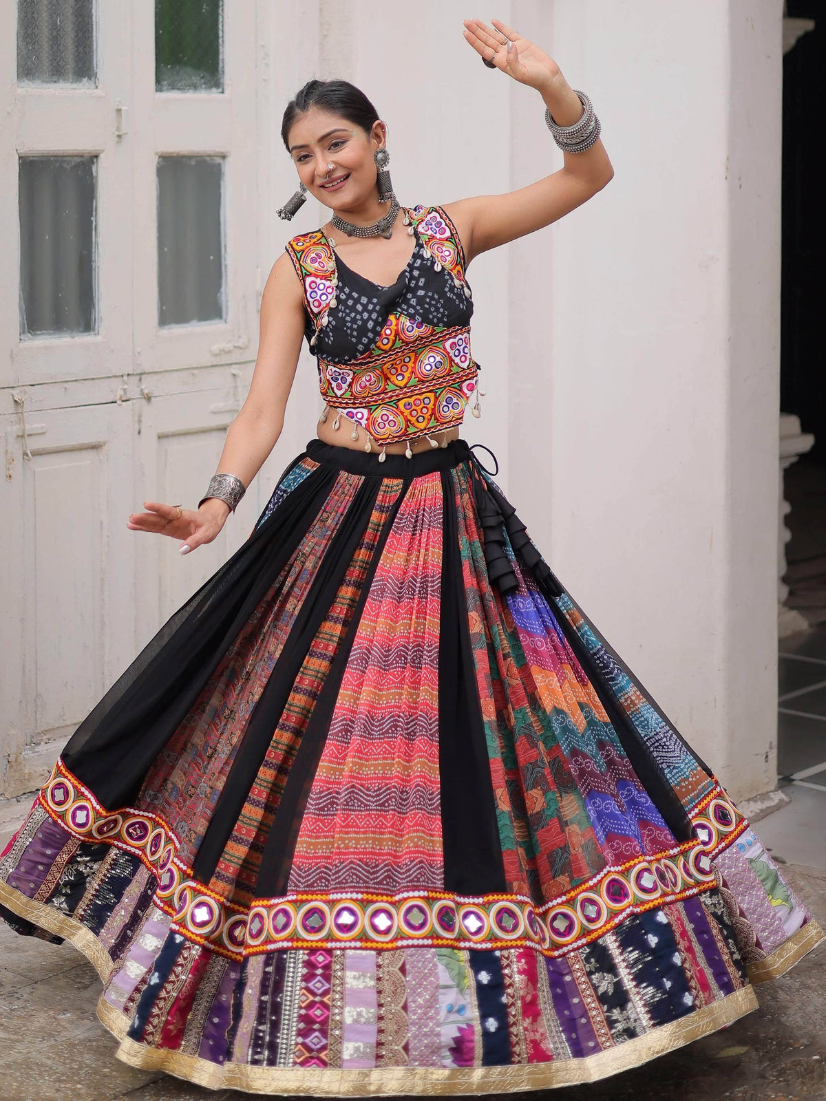 Woman in vibrant Indian ethnic wear, colorful embroidered lehenga choli with mirror work, traditional jewelry