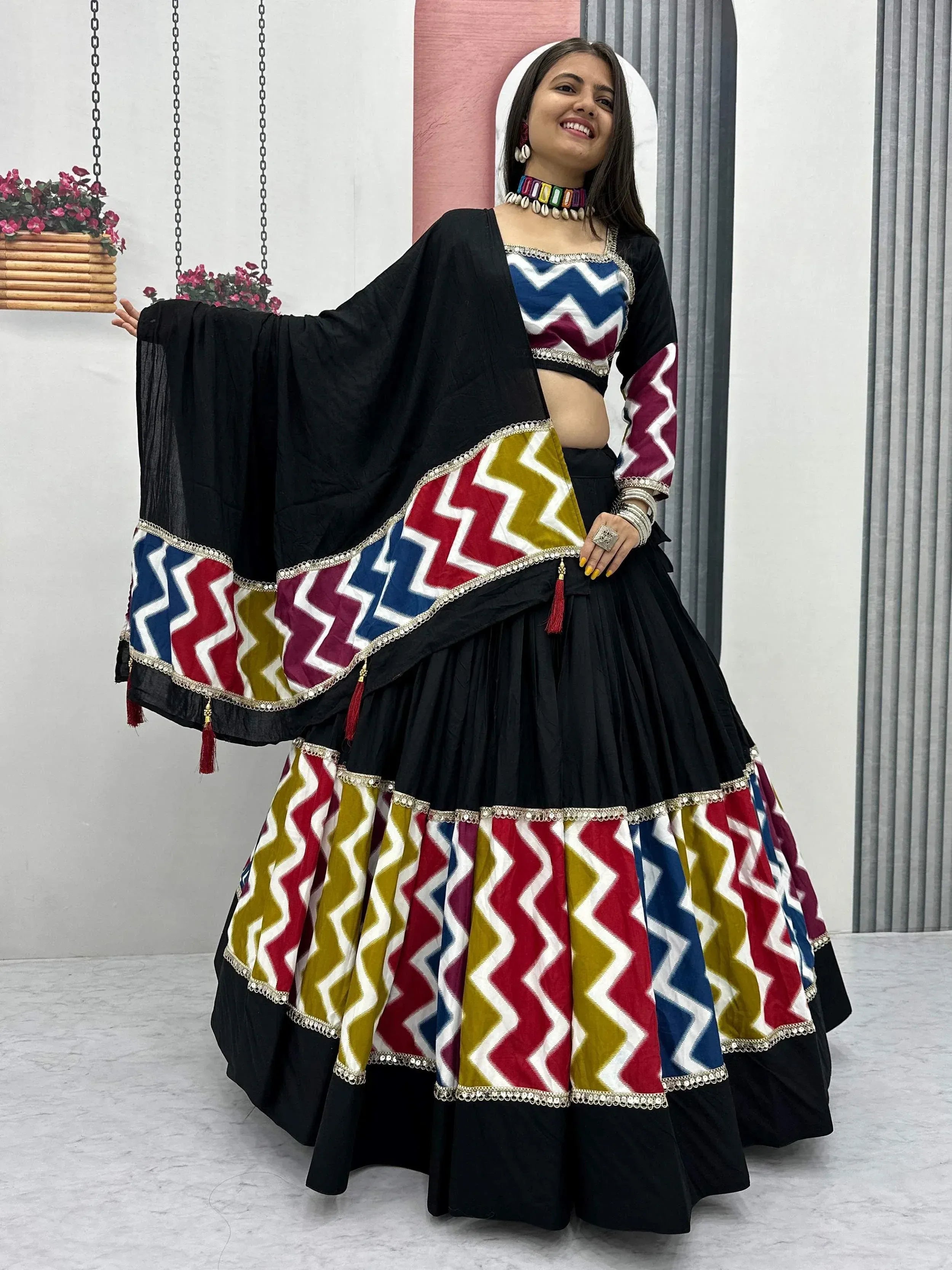 Black lehenga choli with colorful zigzag print and mirror work, perfect for Indian ethnic wear