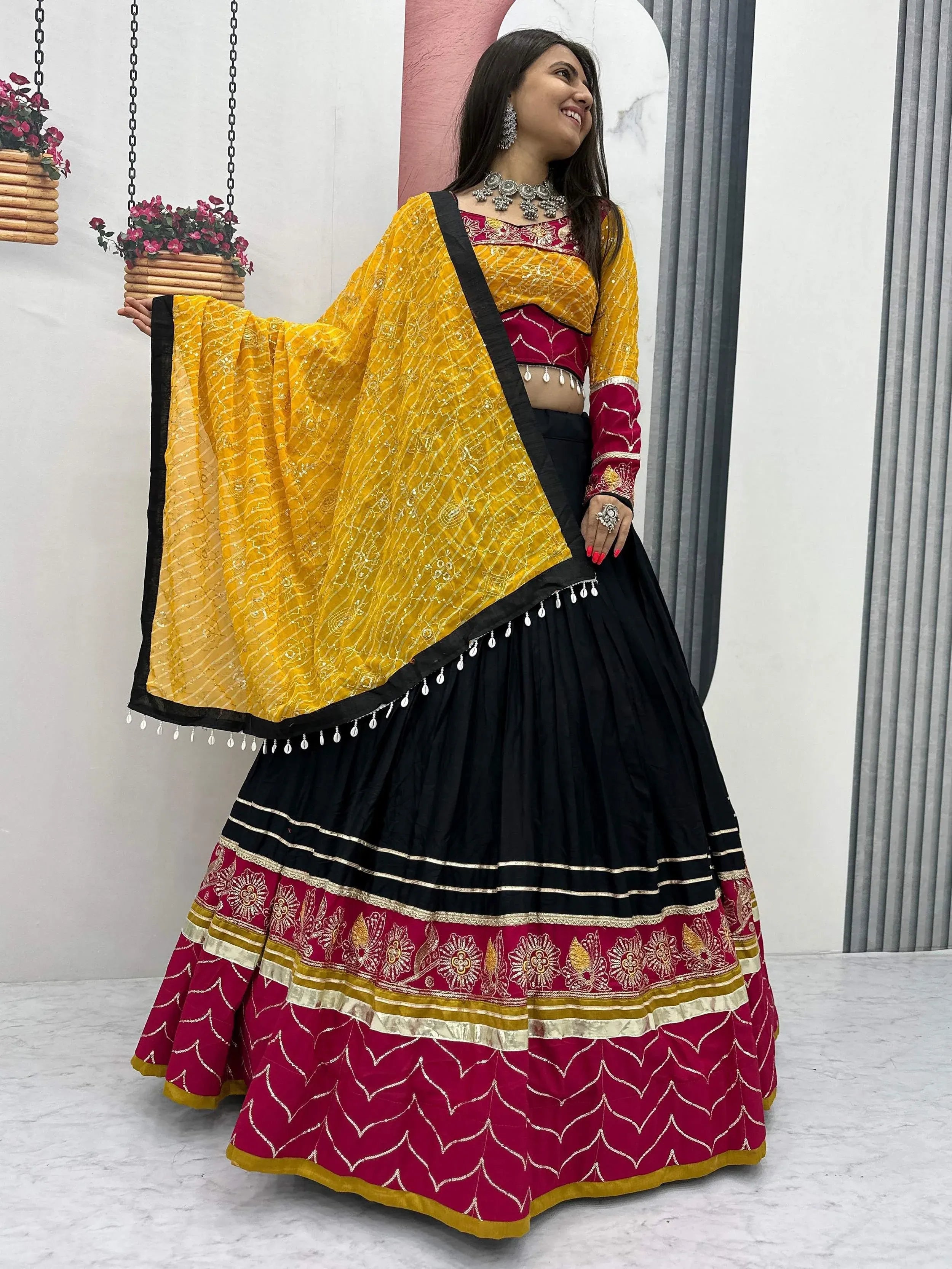 Yellow and black lehenga choli with maroon embroidery, perfect for Indian ethnic wear occasions.