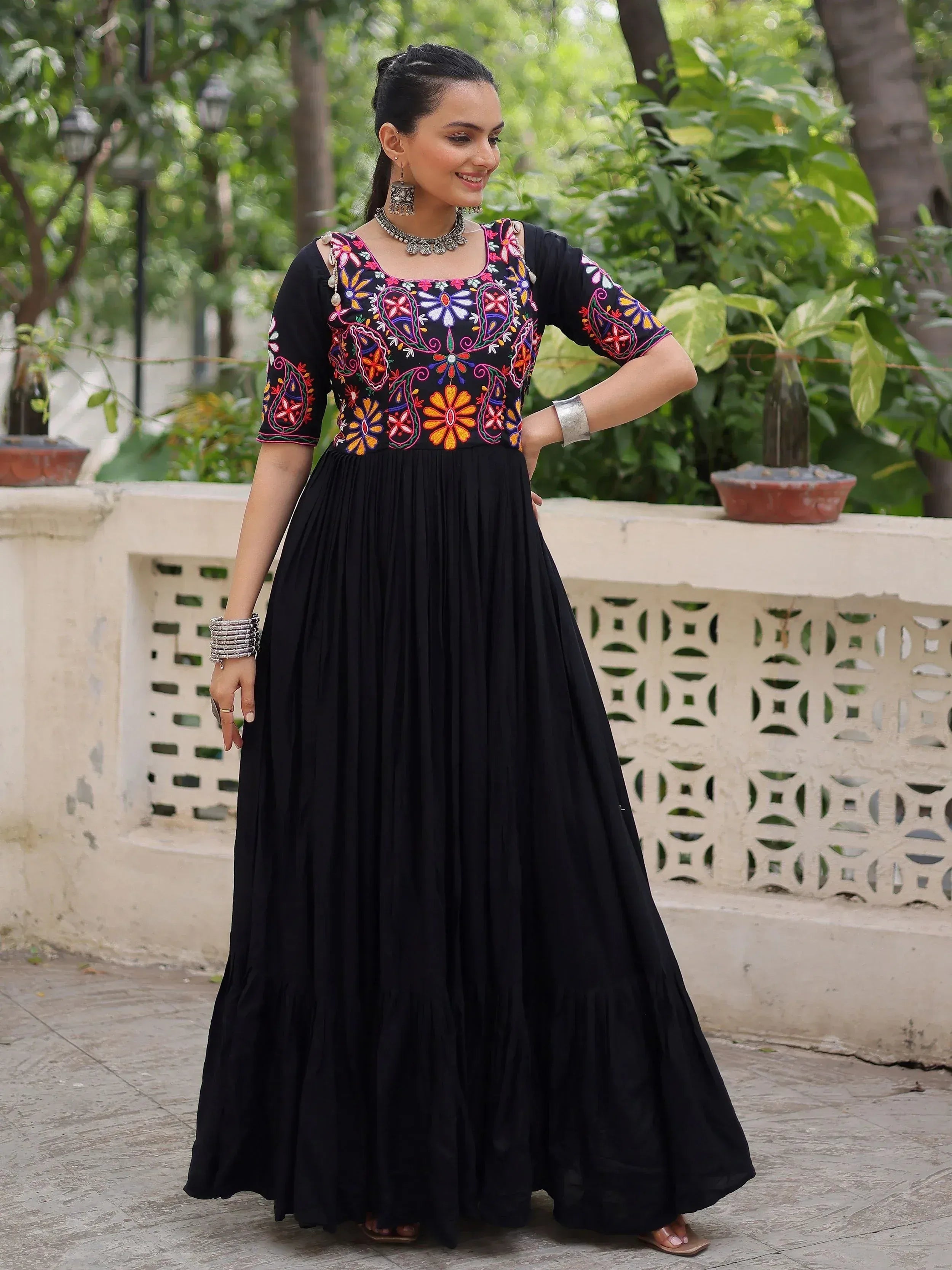 Black ethnic gown with vibrant floral embroidery, perfect for Indian occasions and festive wear.