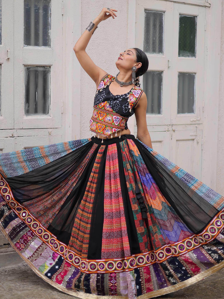Woman in colorful Indian ethnic lehenga choli with mirror work, dancing outdoors