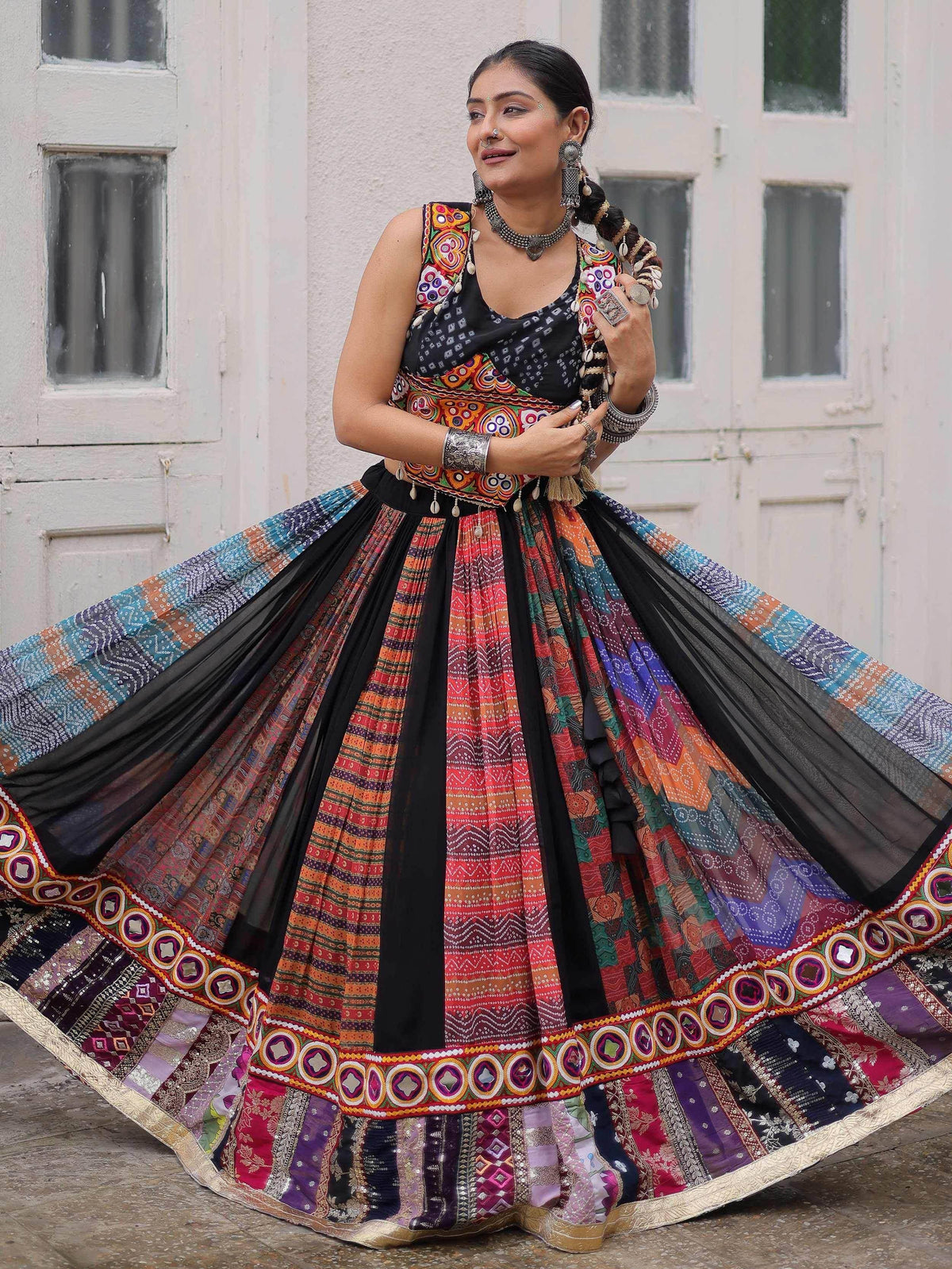 Woman in colorful ethnic Indian lehenga choli with mirror work, perfect for festive occasions and weddings.
