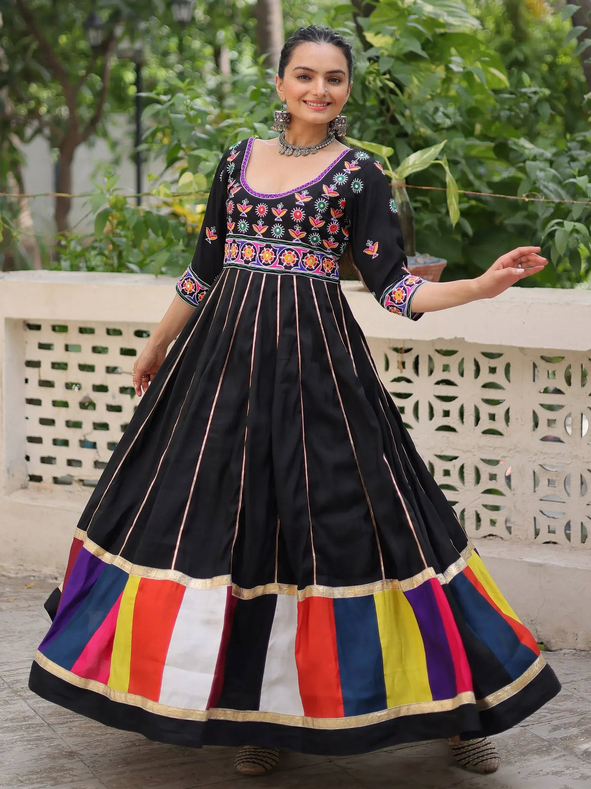 Black embroidered Anarkali with colorful striped skirt, perfect for Indian ethnic wear occasions