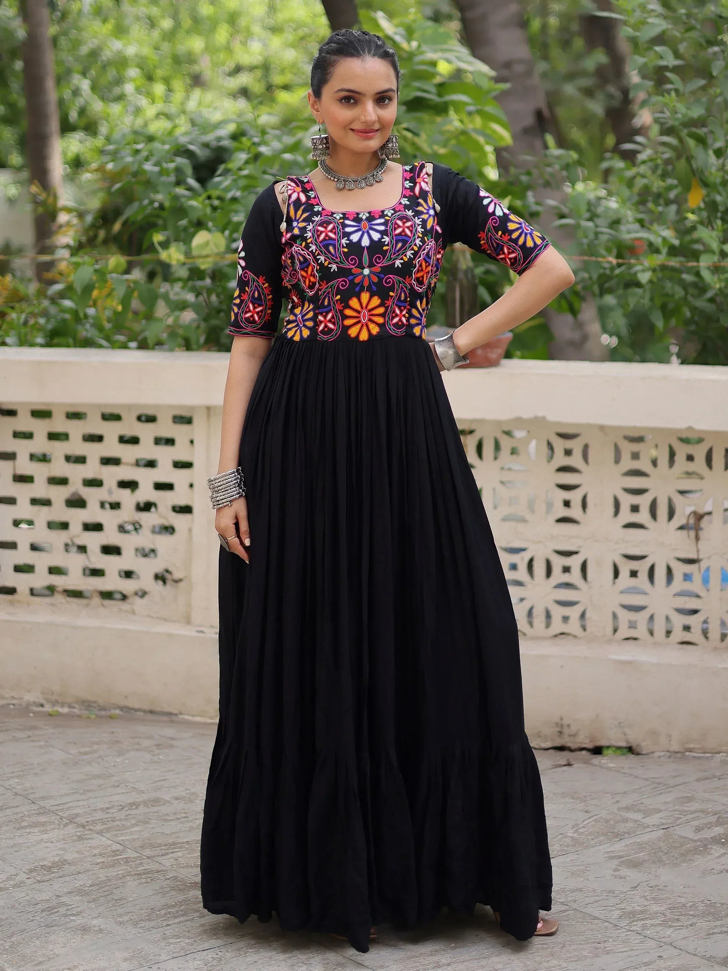 Black ethnic gown with colorful floral embroidery, perfect for Indian occasions and festive wear.