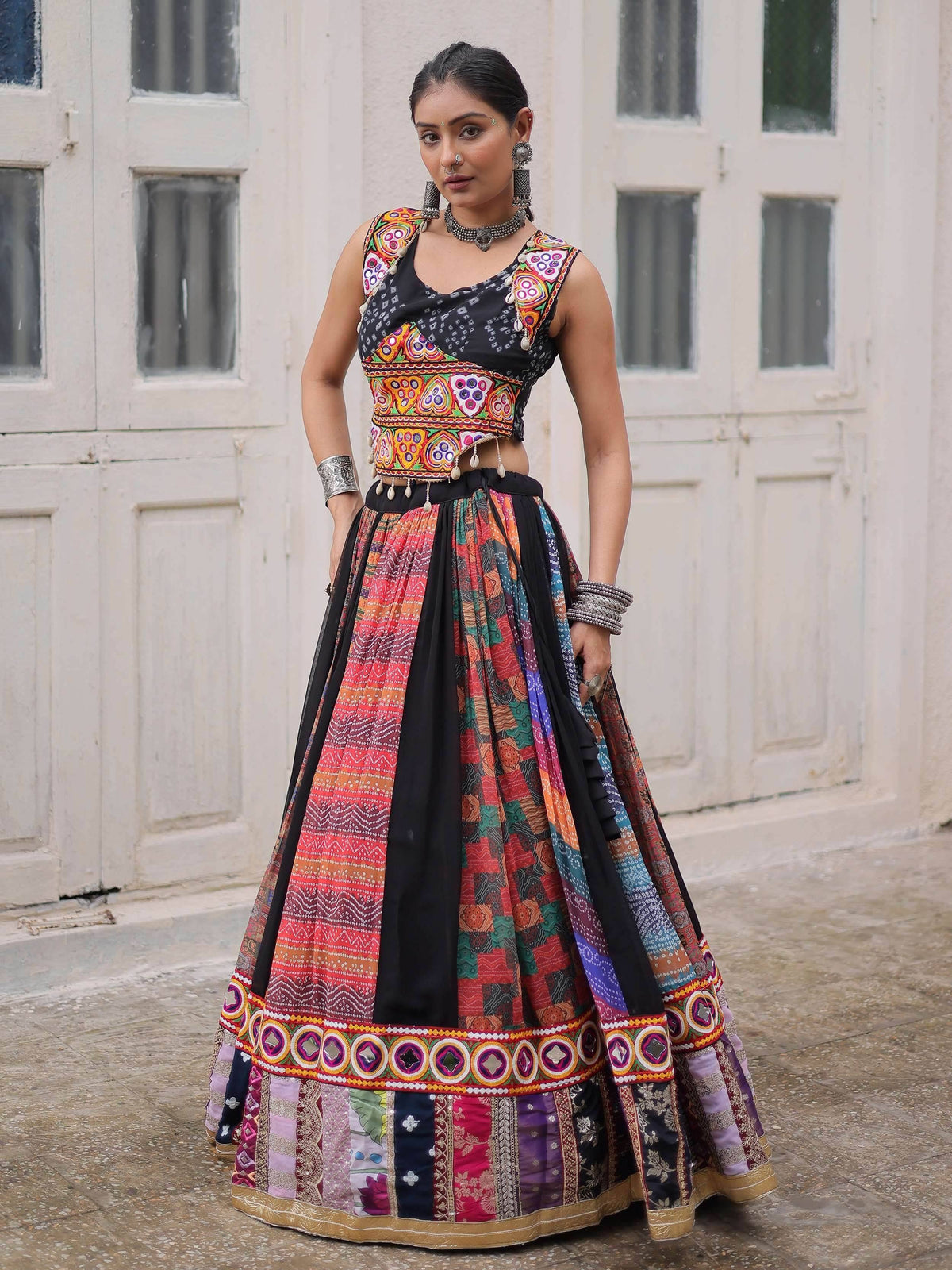 Woman in colorful embroidered lehenga choli with mirror work, traditional Indian ethnic wear