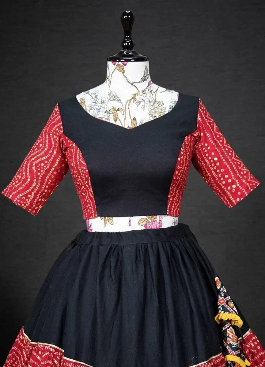 Black and red ethnic gown with printed sleeves and floral waistband, displayed on mannequin