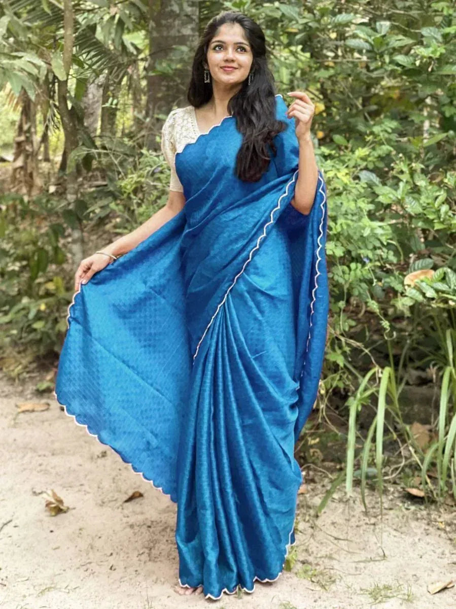 Woman in elegant blue saree with scalloped border, styled for Indian ethnic wear occasions