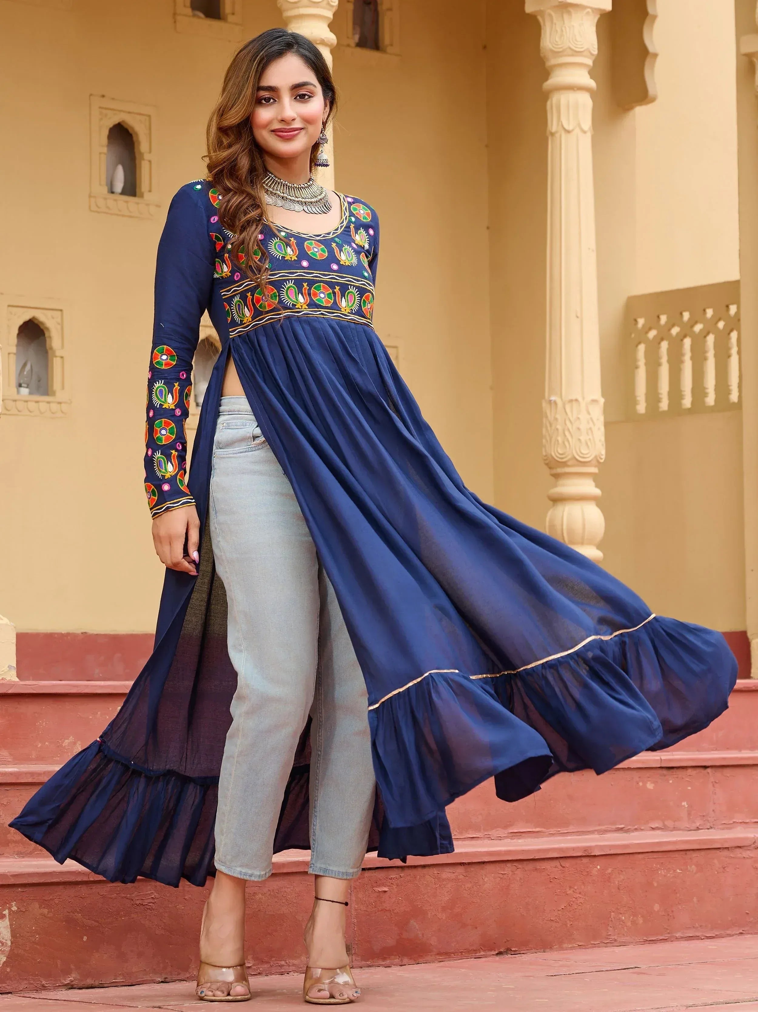Navy blue embroidered ethnic kurti with ruffled hem paired with jeans, perfect for Indian fashion lovers.
