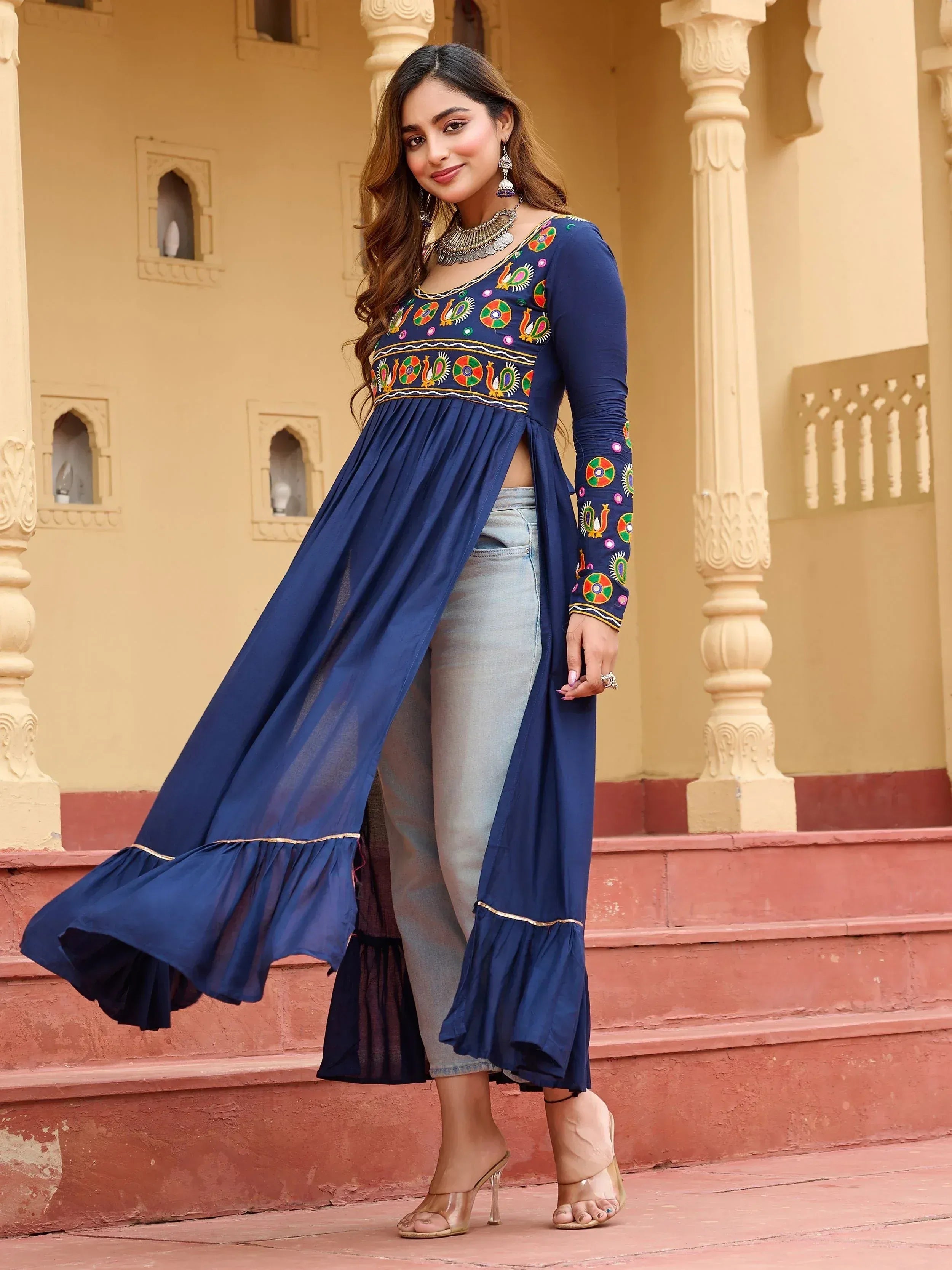 Blue embroidered ethnic gown with flared hem paired with jeans, perfect for Indian wear