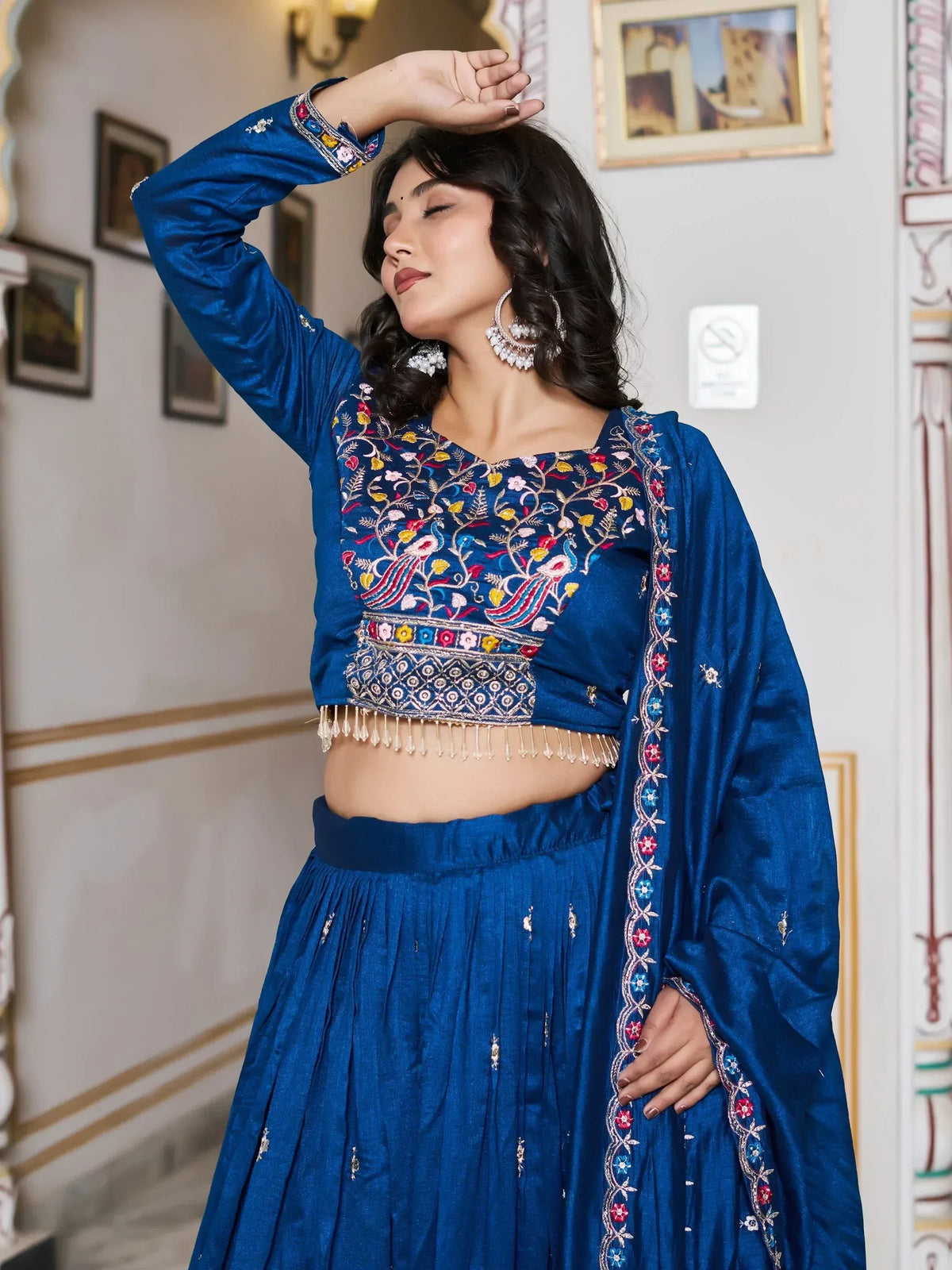 Blue embroidered lehenga choli with floral and peacock motifs, perfect for Indian ethnic wear