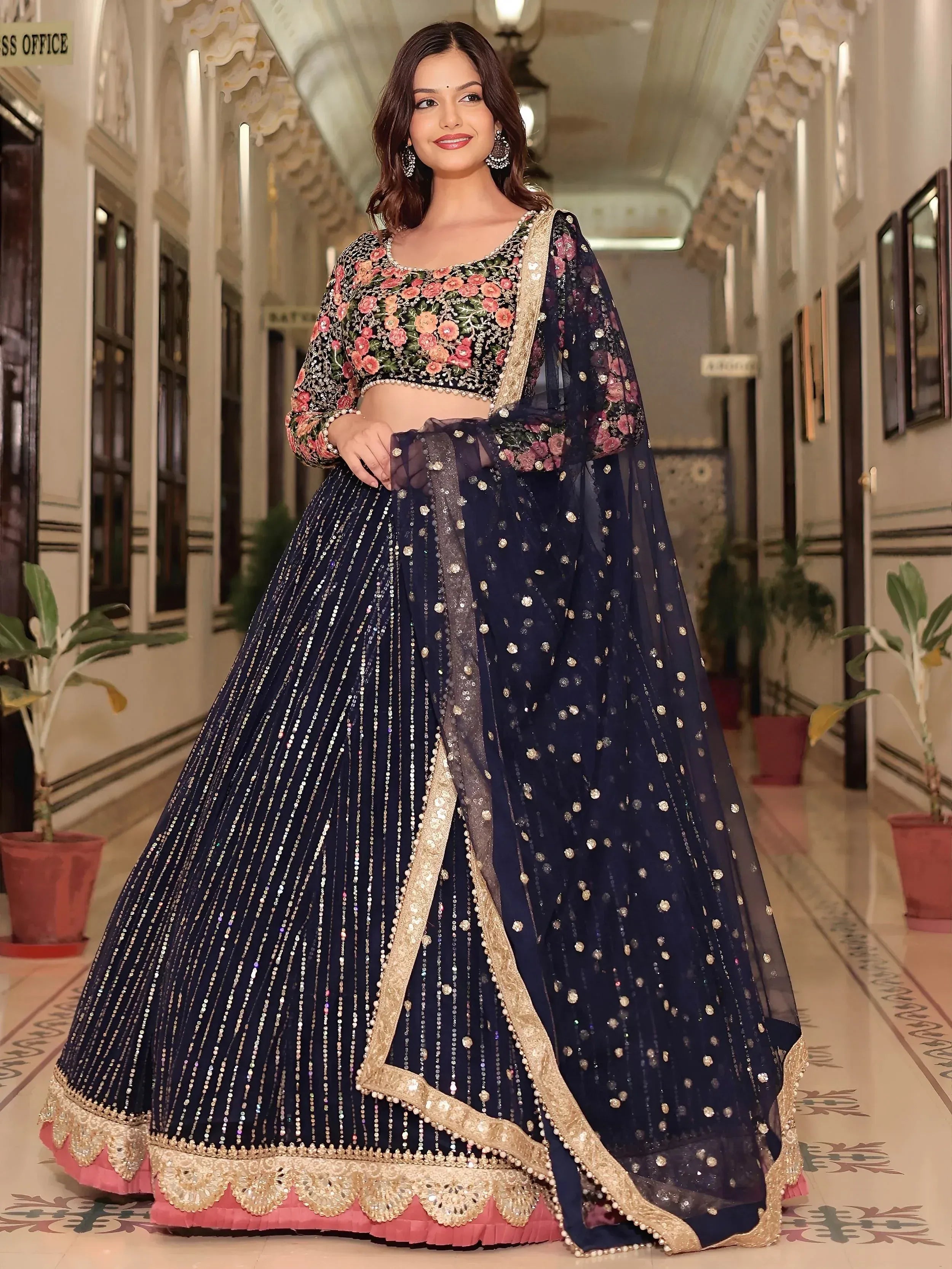 Navy blue floral embroidered lehenga choli with gold detailing, perfect for Indian weddings and festive occasions.
