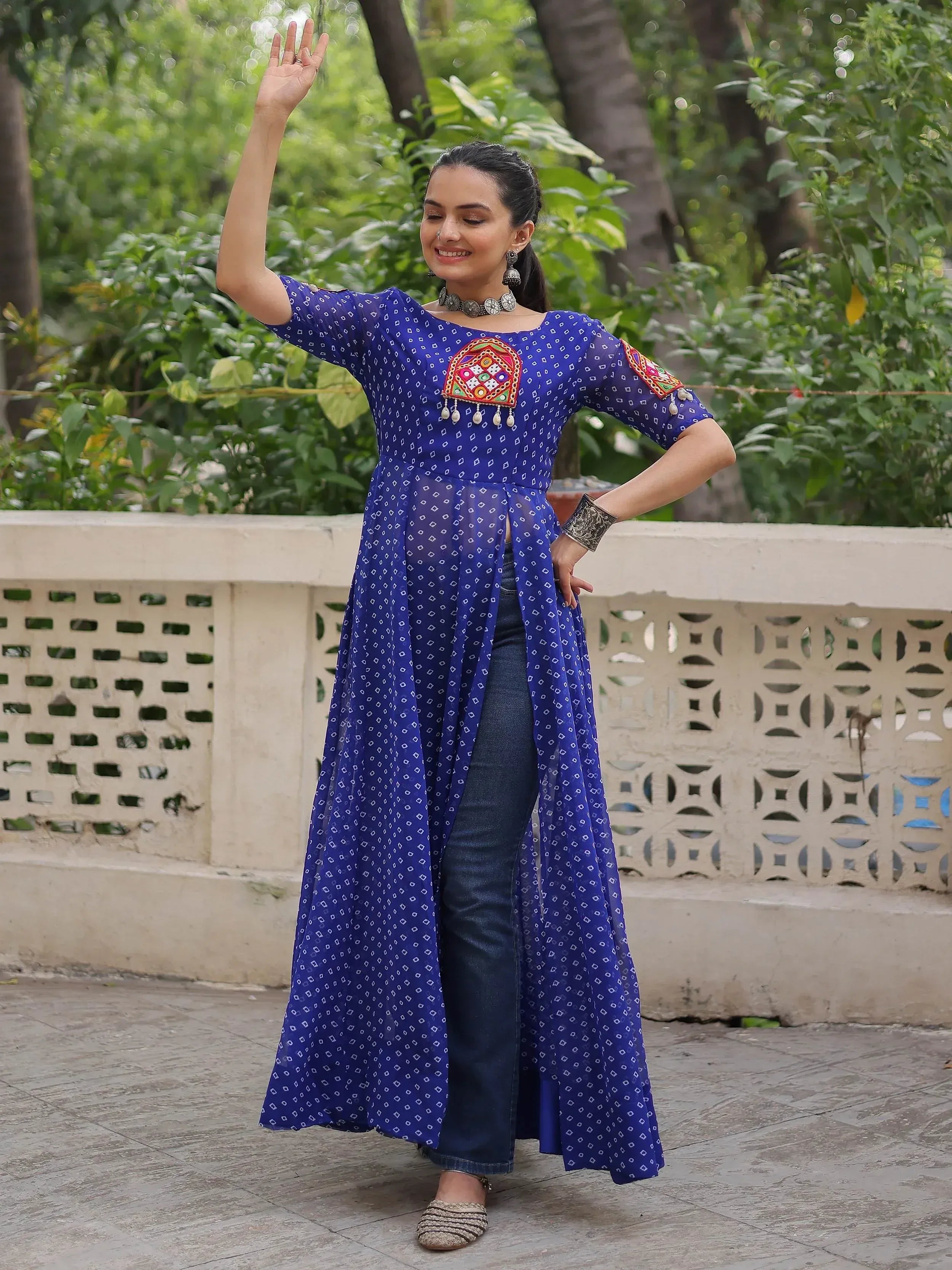 Blue printed ethnic kurti with mirror work, paired with jeans for casual wear