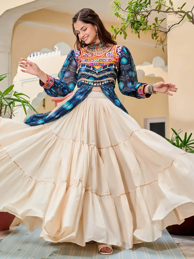Woman in colorful embroidered blue top and cream tiered skirt, Indian ethnic wear