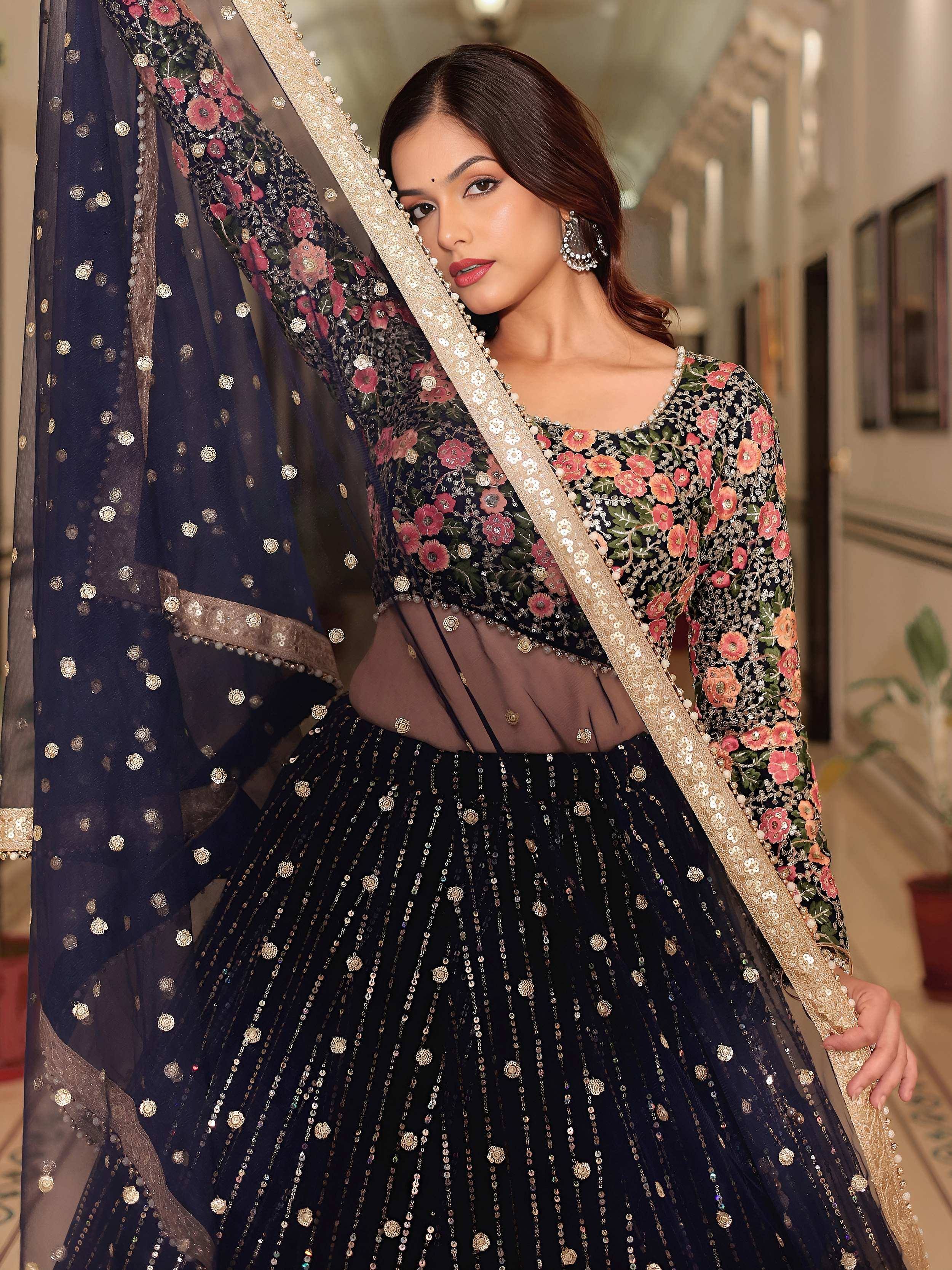 Elegant navy blue lehenga choli with floral embroidery and gold sequins, perfect for Indian ethnic wear.