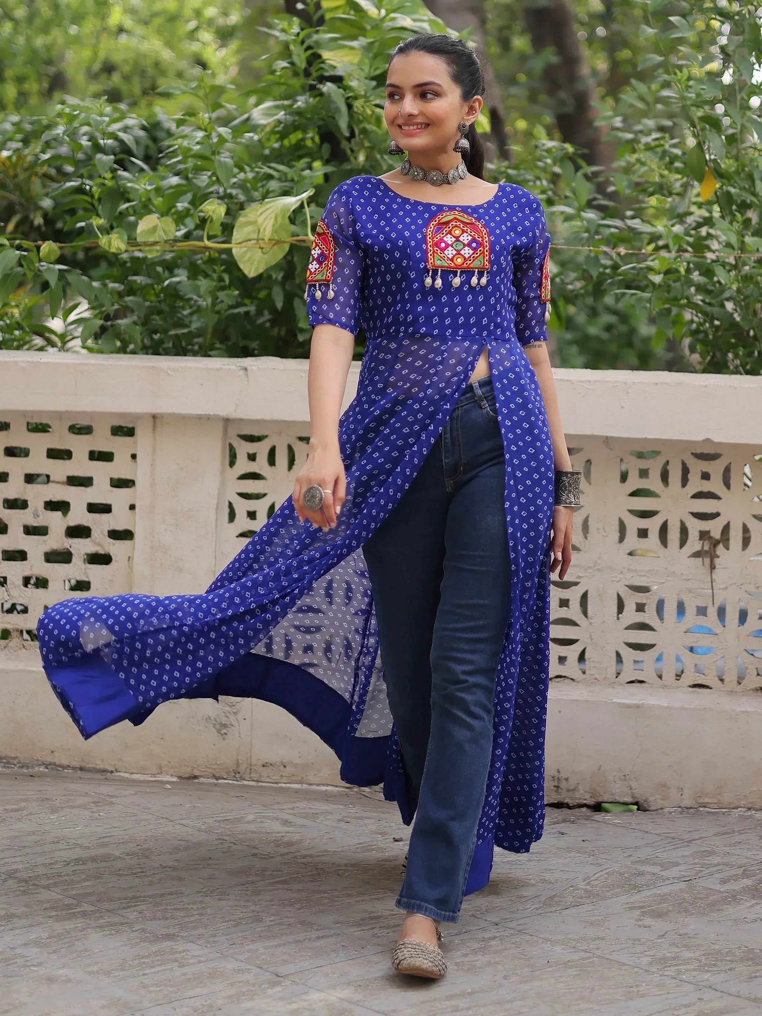 Blue printed ethnic kurta with mirror work, paired with jeans for a fusion look