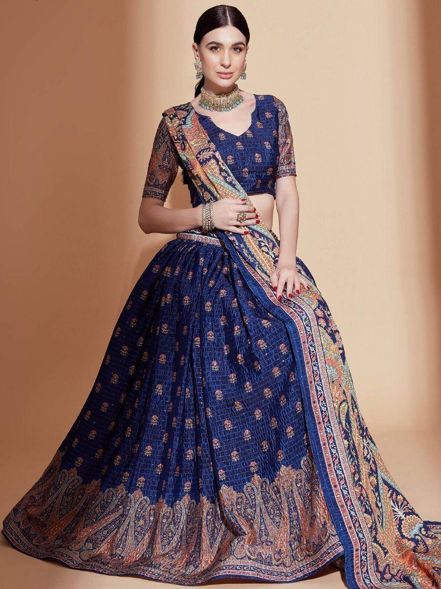 Elegant navy blue lehenga choli with intricate paisley print and embroidered border, perfect for Indian ethnic occasions.