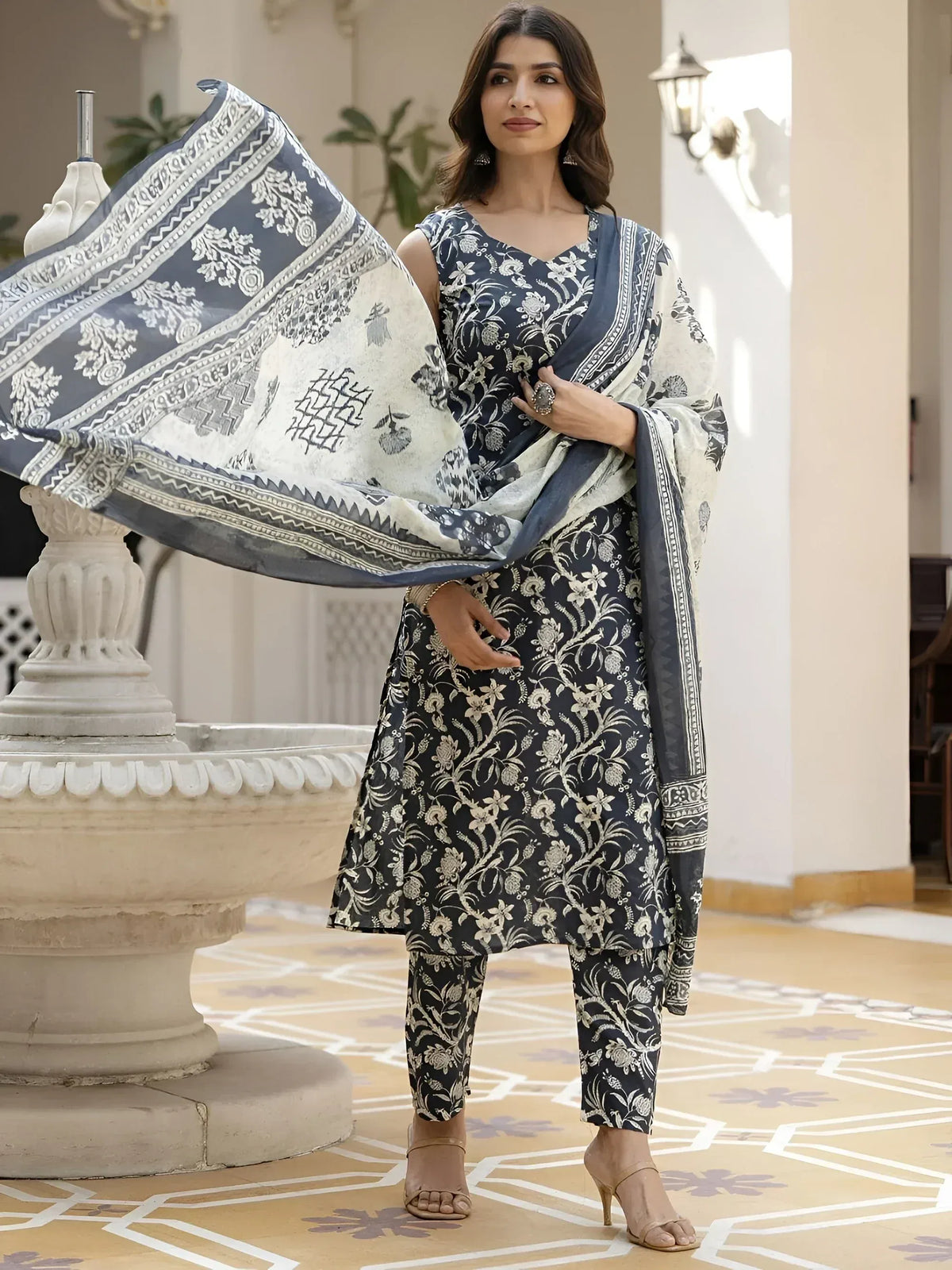 Woman in navy floral print salwar kameez with matching dupatta, ethnic Indian wear
