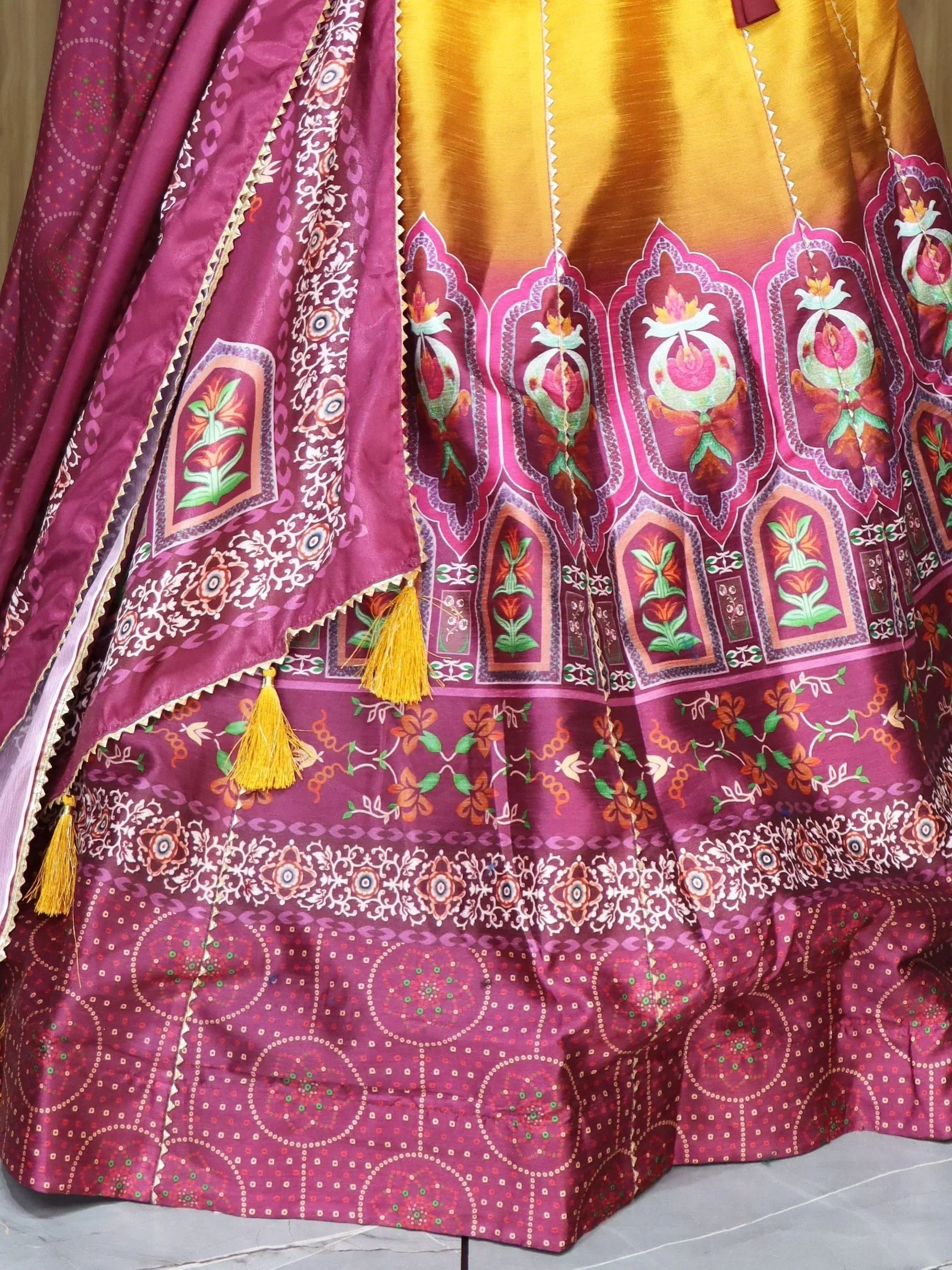 Purple and gold printed lehenga choli with floral motifs and tassels, Indian ethnic wear