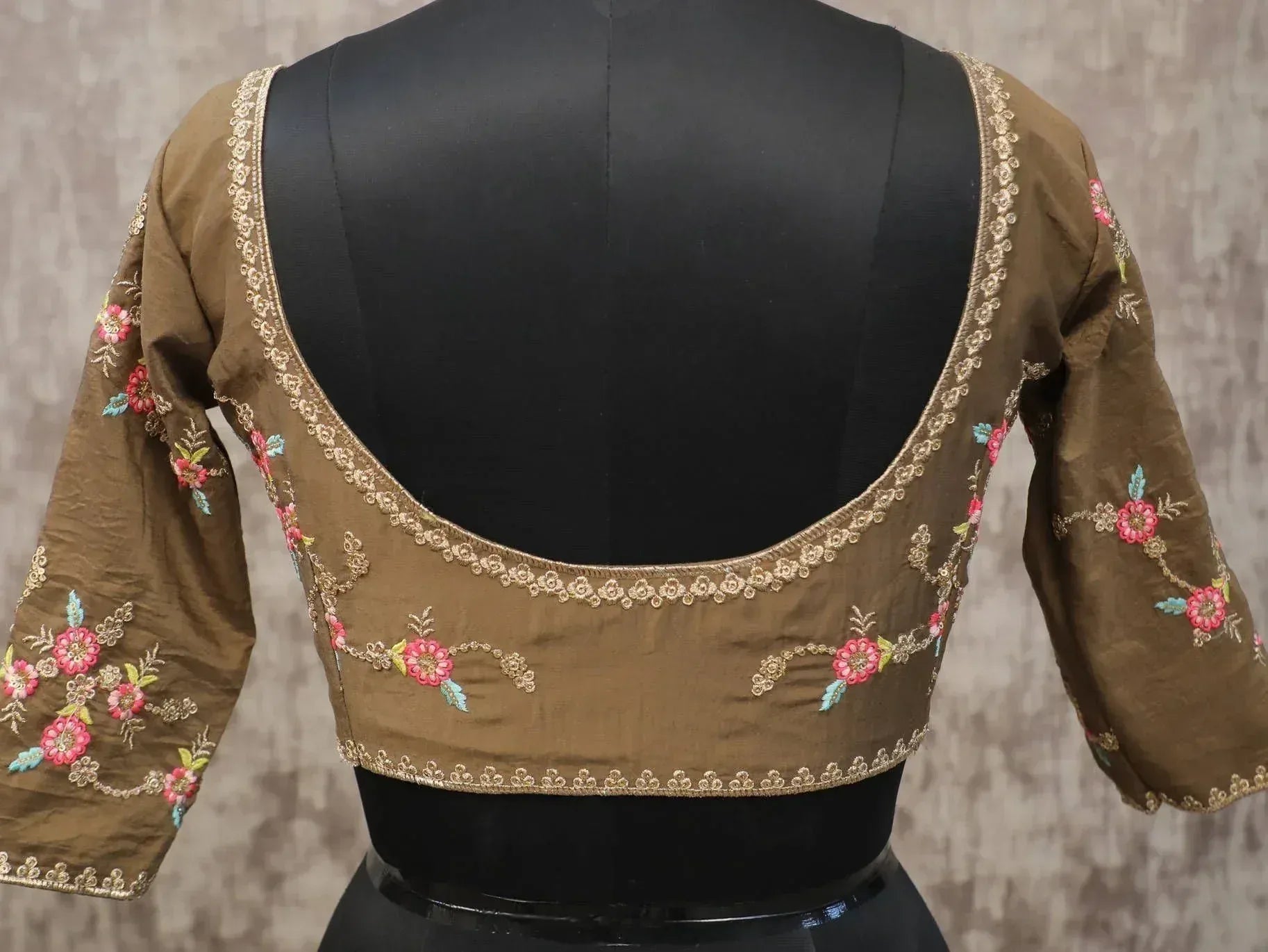 Brown embroidered blouse with floral design, perfect for lehenga choli or saree, featuring gold trim and 3/4 sleeves.