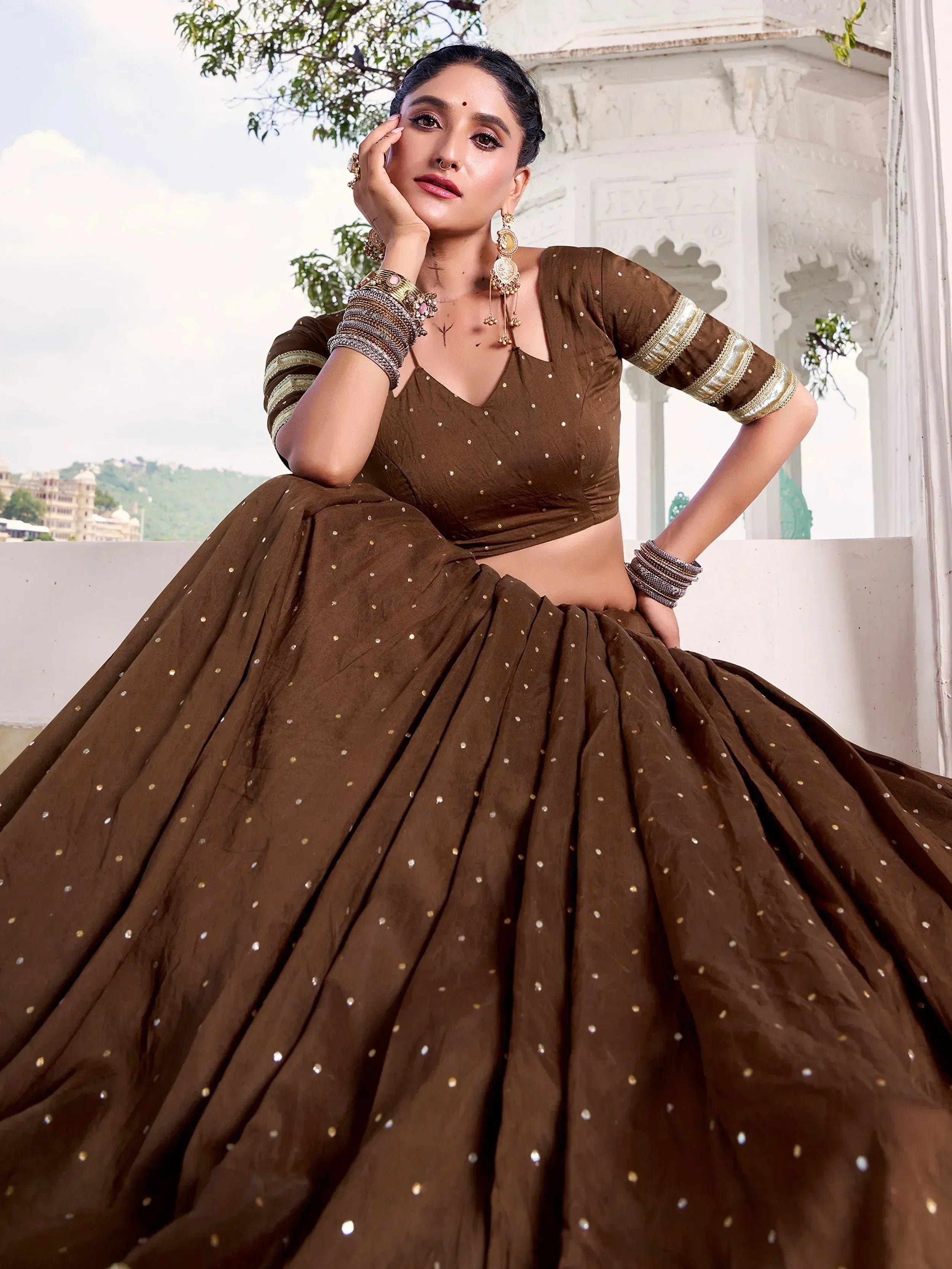 Brown designer lehenga choli with gold embellishments, perfect for Indian ethnic wear occasions