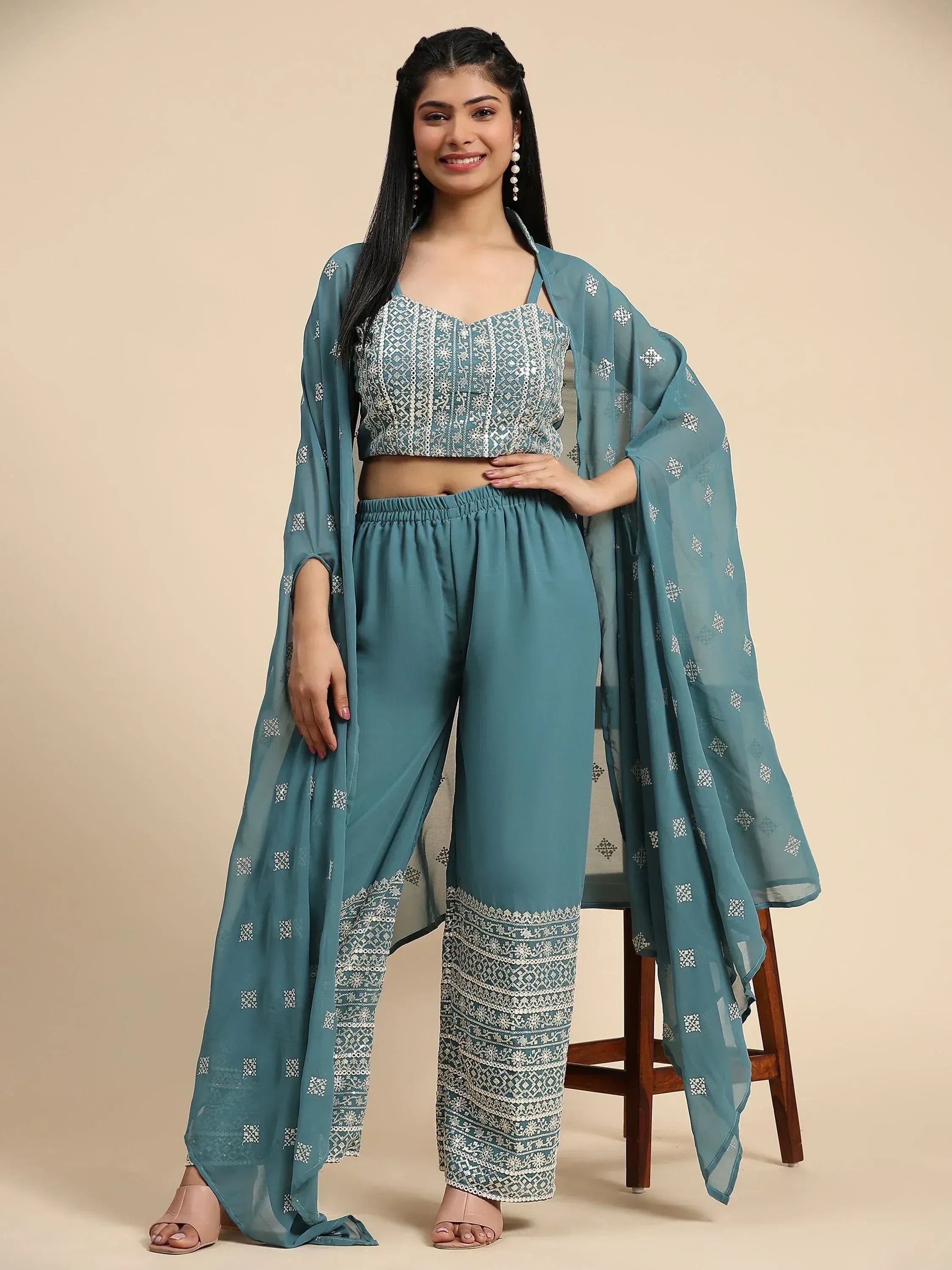 Woman wearing teal ethnic embroidered crop top, palazzo pants, and matching dupatta