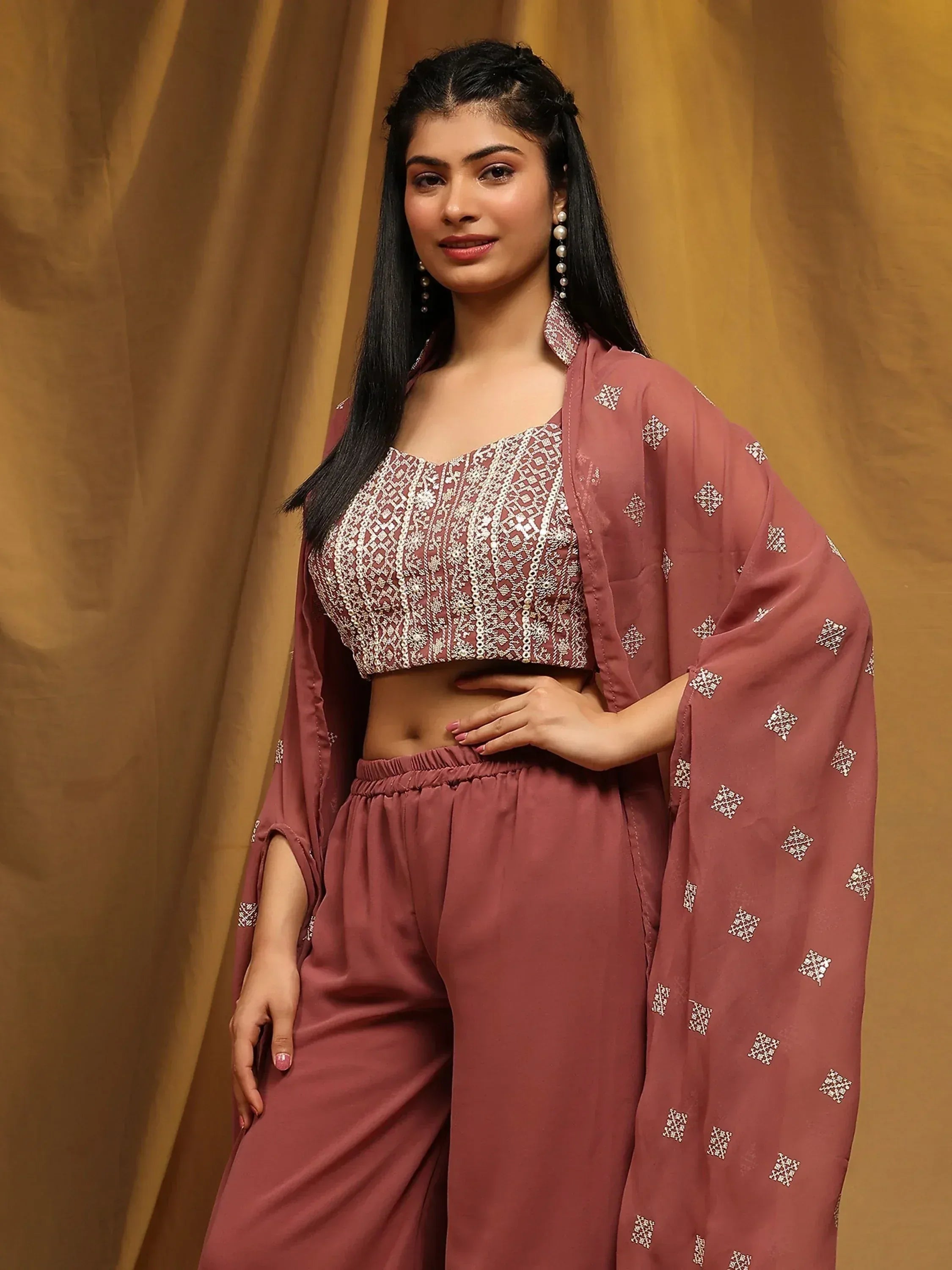 Woman in mauve embroidered ethnic three-piece set with crop top, palazzo pants, and dupatta