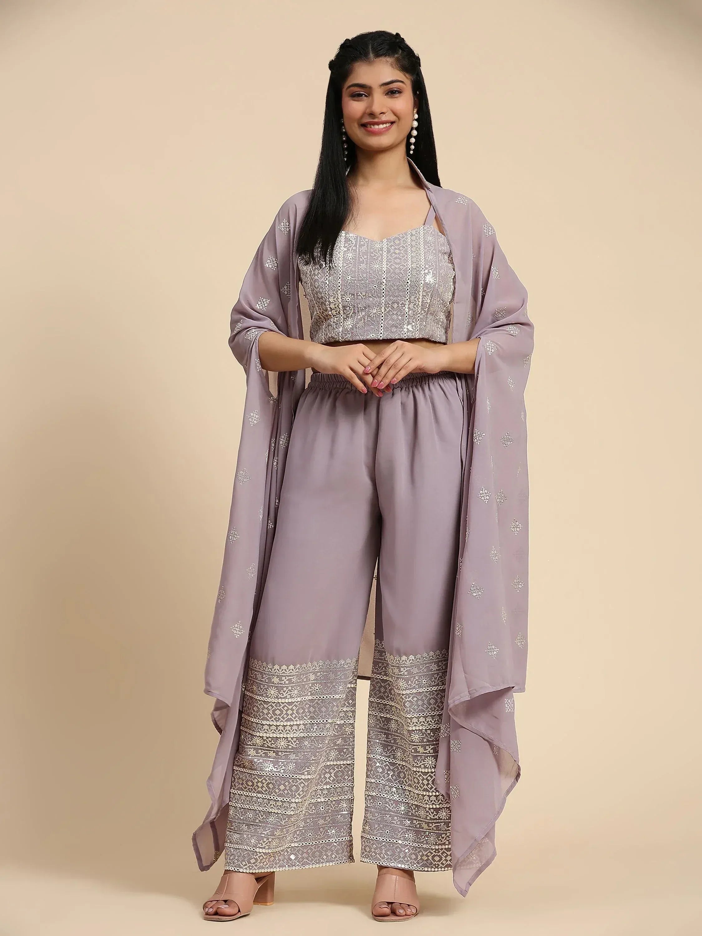 Woman in lavender embroidered ethnic palazzo set with dupatta, smiling, standing