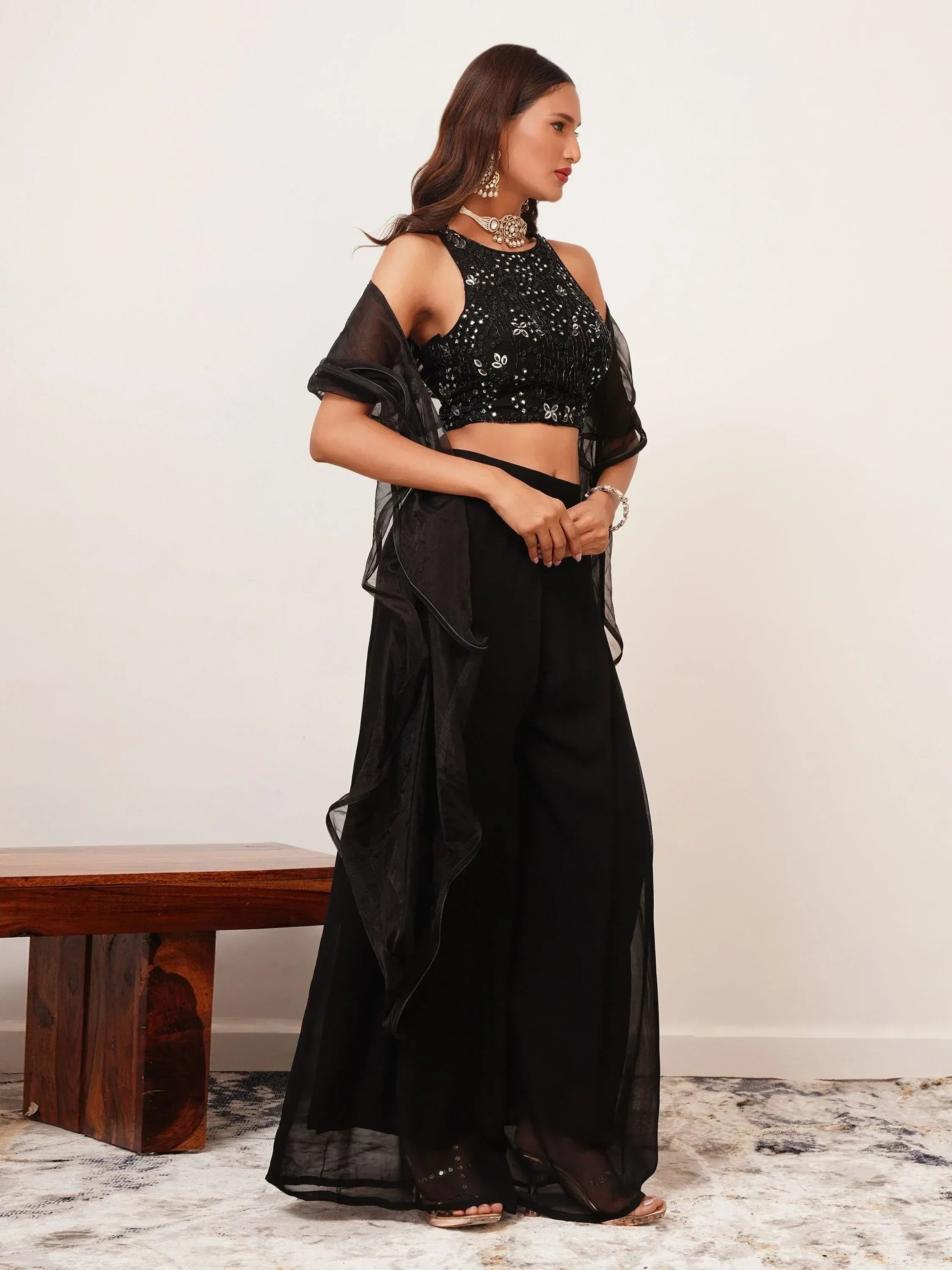 Woman in black sequin ethnic crop top and palazzo set with dupatta, side pose