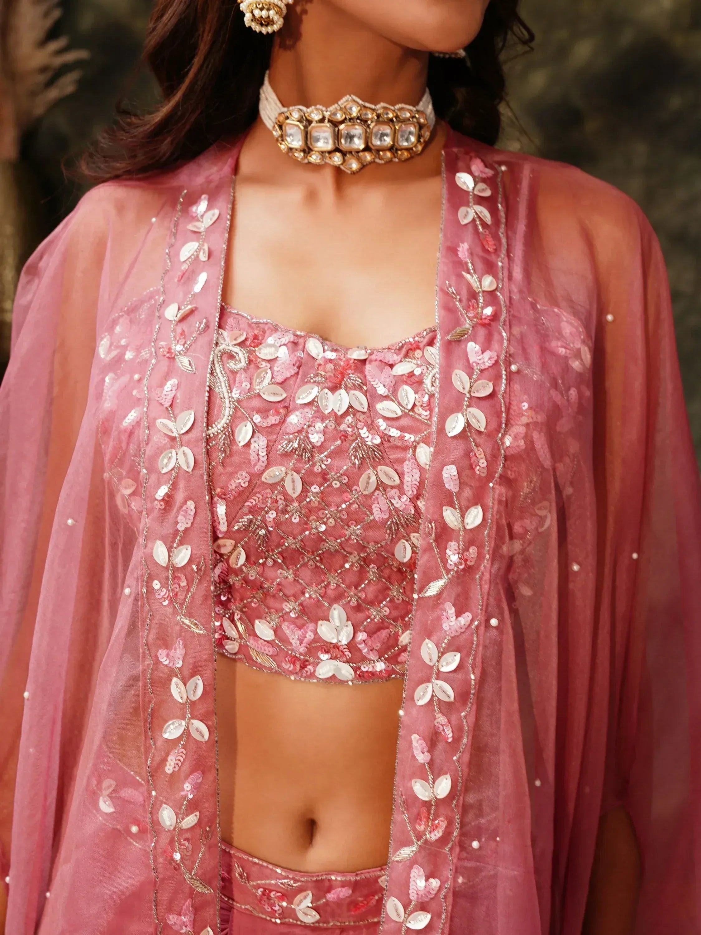 Pink embroidered lehenga choli with sheer dupatta and statement jewelry for Indian ethnic wear